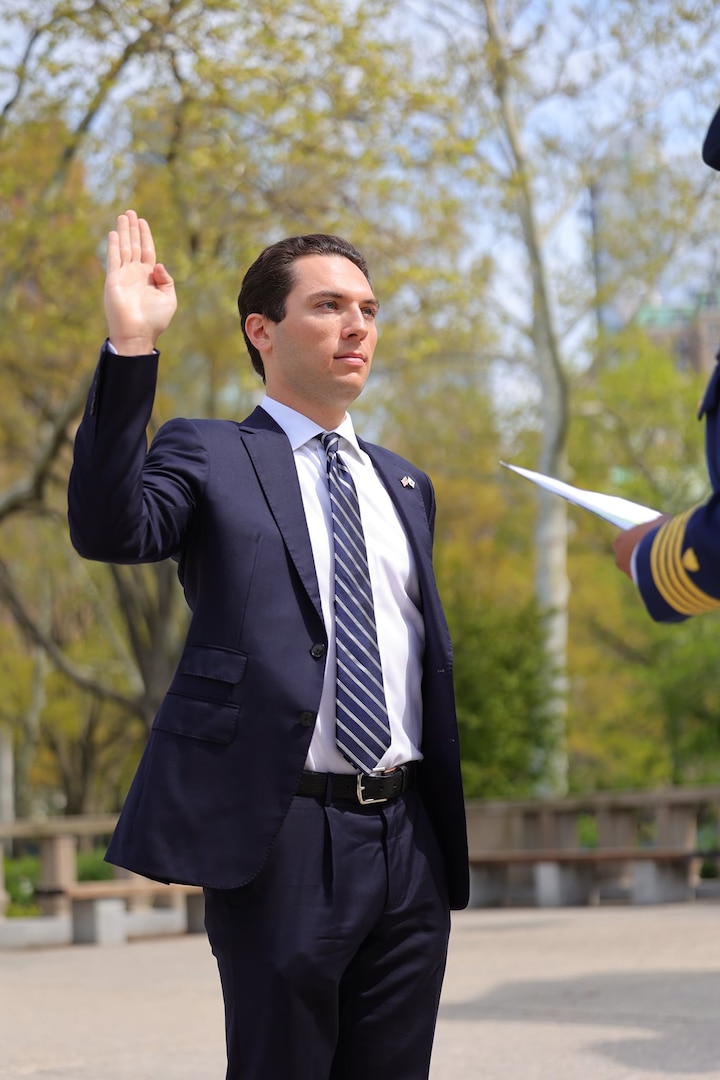 Ensign Michael Barth takes his oath of office with Capt. Zeita Merchant, Sector New York commander, in front of friends and family, May 3, 2022, at the Battery Park World War II Memorial. (Coast Guard Photo by Daniel Henry)