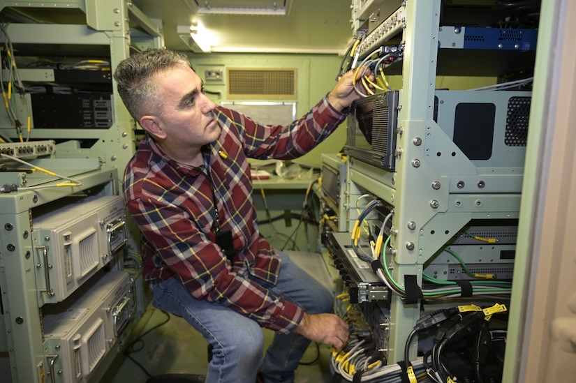 Photo of a man inspecting wires inside a Single Shelter Switch