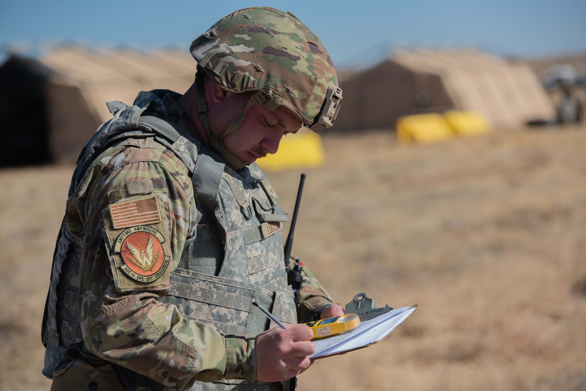 Photo of Airman recording data