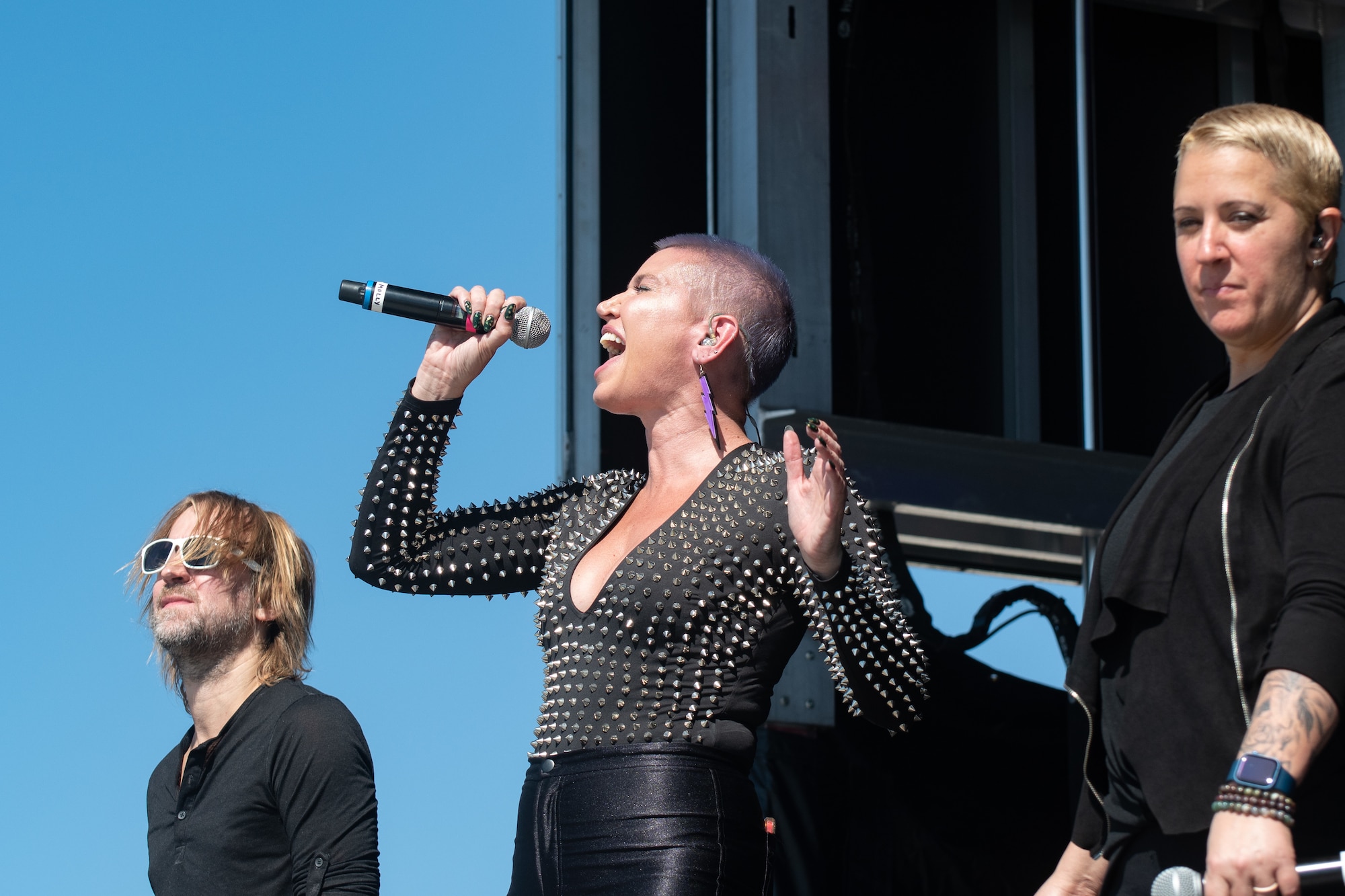 A woman sings into a microphone.