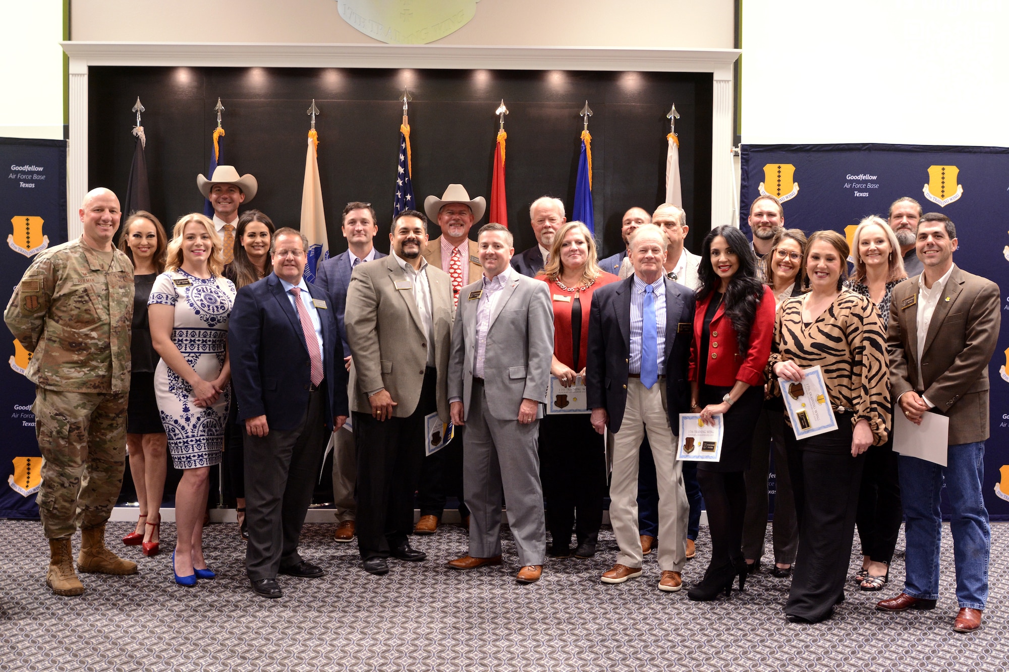 The class of 2022-2023 Honorary Commanders stand for a photo at the Powell Event Center, Goodfellow Air Force Base, Texas, Oct. 25, 2022. The Honorary Commander Program allows community leaders an active role in the base, immerses them in the mission to strengthen community relations and provide a networking opportunity. (U.S. Air Force photo by Senior Airman Abbey Rieves)