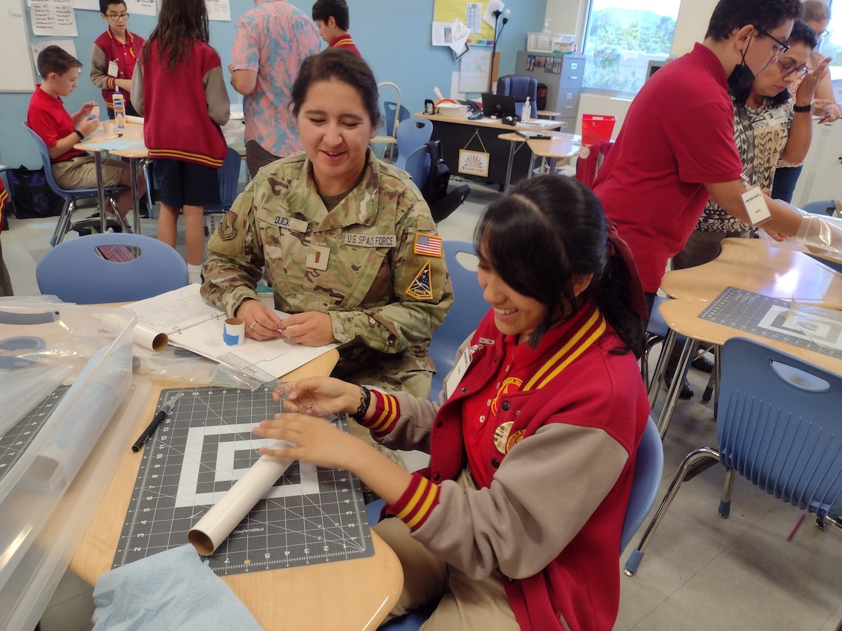 2nd Lt. Latofat Quick, a volunteer mentor from the Air Force Research Laboratory, assists a student during a rocket build at DOD STARBASE NM, at Kirtland Air Force Base, New Mexico, Sept. 8, 2022. The program was recently elevated to Level-III status, the highest level of accreditation.