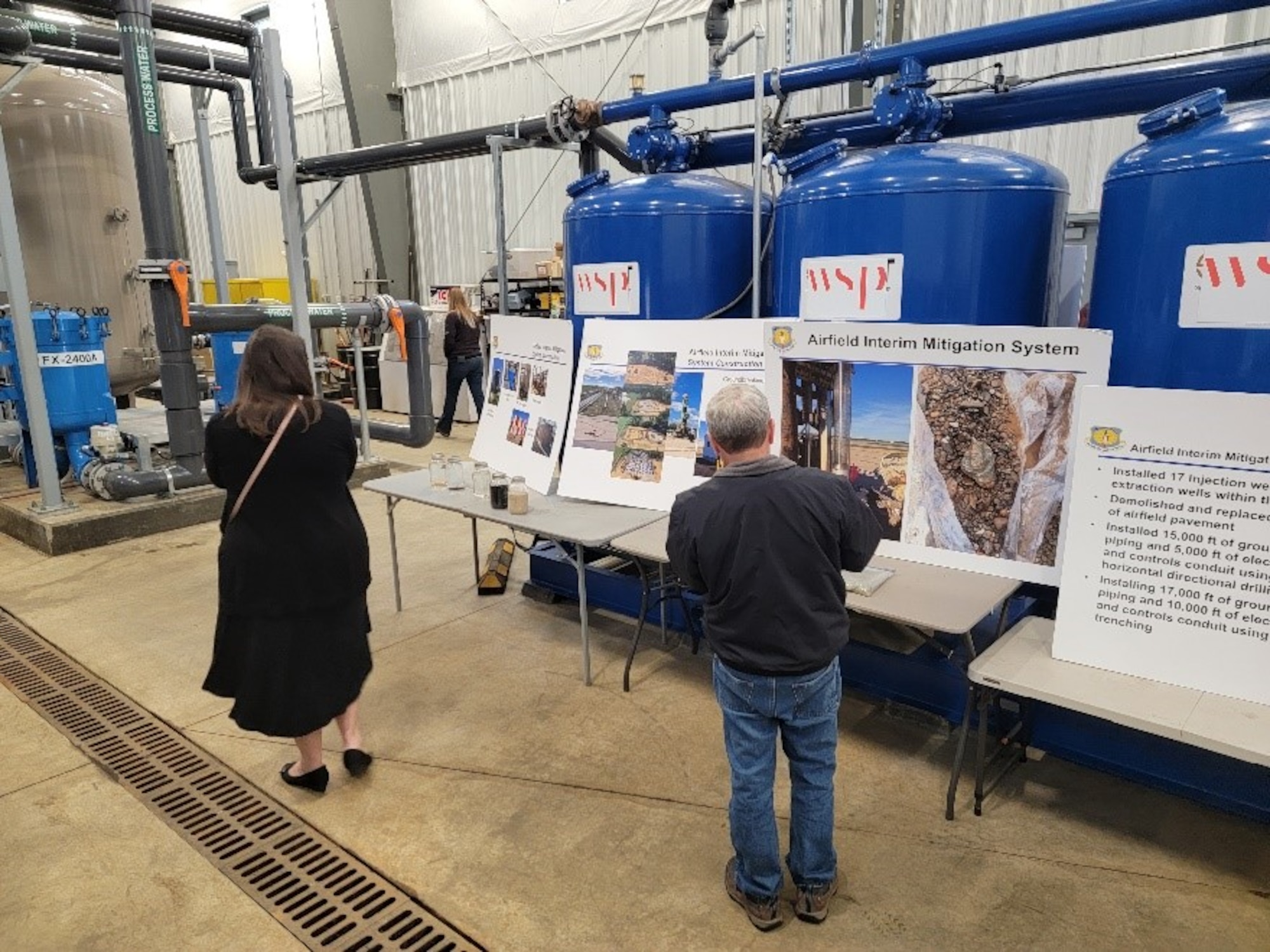RAB members review equipment and posters explaining cleanup