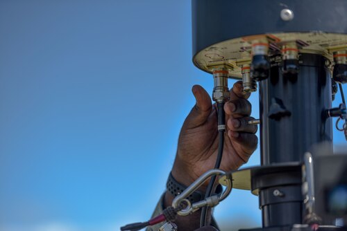 U.S. Air Force Staff Sgt. James Glover, 15th Aircraft Maintenance Squadron crew chief, installs the omni-directional antenna on the portable operations network integrator during an innovation demonstration at Joint Base Pearl Harbor-Hickam, Hawaii, Oct. 18, 2022. Glover and other Airmen are demonstrating the advances in the multi-capable Airmen concept. MCA is an initiative where a small group of Airmen are trained to accomplish tasks outside their  Air Force specialty. (U.S. Air Force photo by Tech. Sgt. Anthony Nelson Jr.)