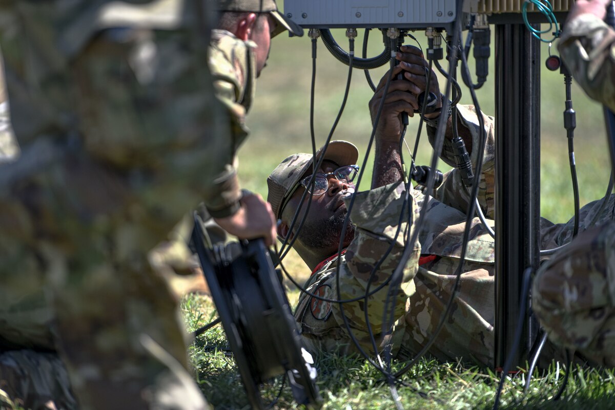 U.S. Air Force Staff Sgt. James Glover, 15th Aircraft Maintenance Squadron crew chief, installs the omni-directional antenna on the portable operations network integrator during an innovation demonstration at Joint Base Pearl Harbor-Hickam, Hawaii, Oct. 18, 2022. Glover and other Airmen are demonstrating the advances in the multi-capable Airmen concept. MCA is an initiative where a small group of Airmen are trained to accomplish tasks outside their  Air Force specialty. (U.S. Air Force photo by Tech. Sgt. Anthony Nelson Jr.)