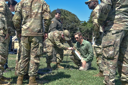 Airmen from the 15th Aircraft Maintenance Squadron and civilian partners from the Under Secretary of Defense for research and engineering office demonstrate the portable operations network integrator at Joint Base Pearl Harbor-Hickam, Hawaii, Oct. 18, 2022.  These Airmen are expanding their knowledge, skills and abilities to better engage in the agile combat employment framework required for multi-capable Airmen to foster ready forces for combatant commanders. (U.S. Air Force photo by Tech. Sgt. Anthony Nelson Jr.)