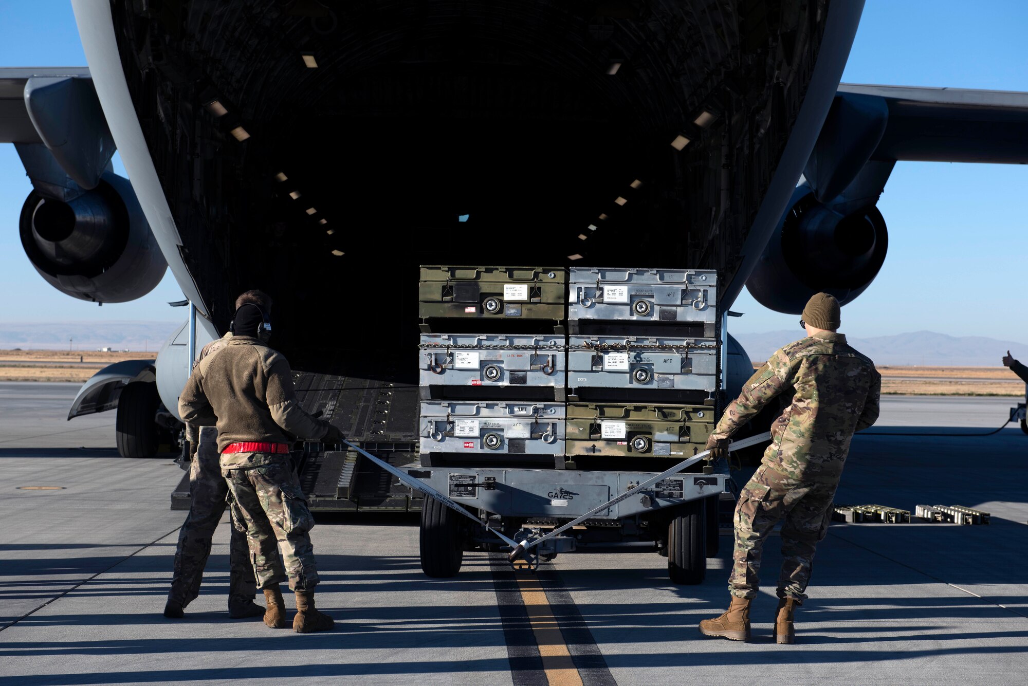 U.S. Airmen with the 62d Aerial Port Squadron load cargo onto a C-17 Globemaster III during Exercise Rainier War 22B at Mountain Home Air Force Base, Idaho, Oct. 17, 2022. In addition to showcasing Air Force Generation prioritization, Rainier War is the 62d Airlift Wing’s full-scale exercise used to train Multi-capable Airmen. (U.S. Air Force photo by Staff Sgt. Zoe Thacker)