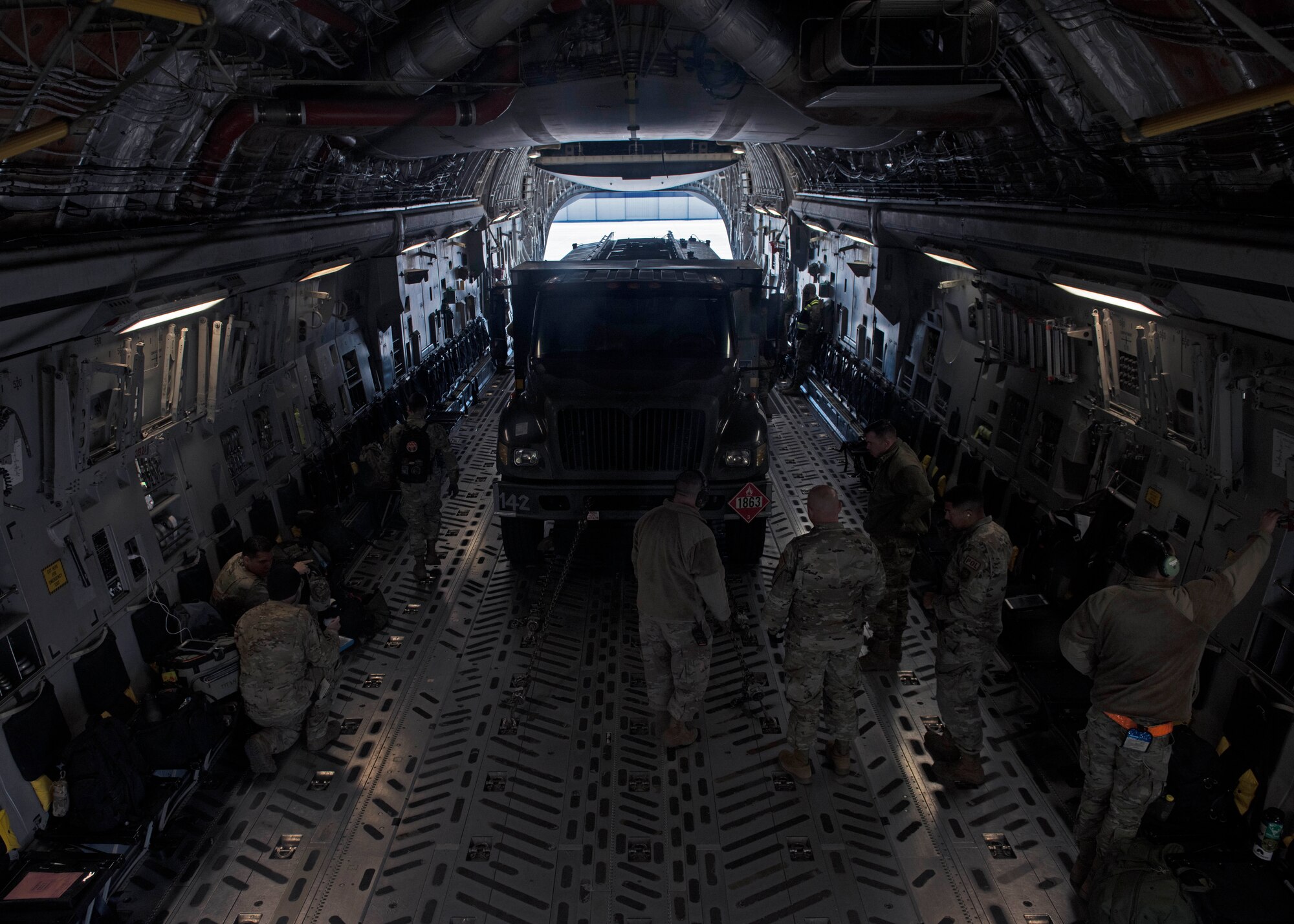 U.S. Airmen with the simulated 7th Expeditionary Airlift Squadron load cargo onto a C-17 Globemaster III aircraft during Exercise Rainier War 22B at Mountain Home Air Force Base, Idaho, Oct. 17, 2022. Airmen from multiple Team McChord units came together to form the 7th EAS during Rainier War 22B; which is a full-scale readiness exercise simulating a deployment in support of U.S. Indo-Pacific areas of responsibility. (U.S. Air Force photo by Staff Sgt. Zoe Thacker)