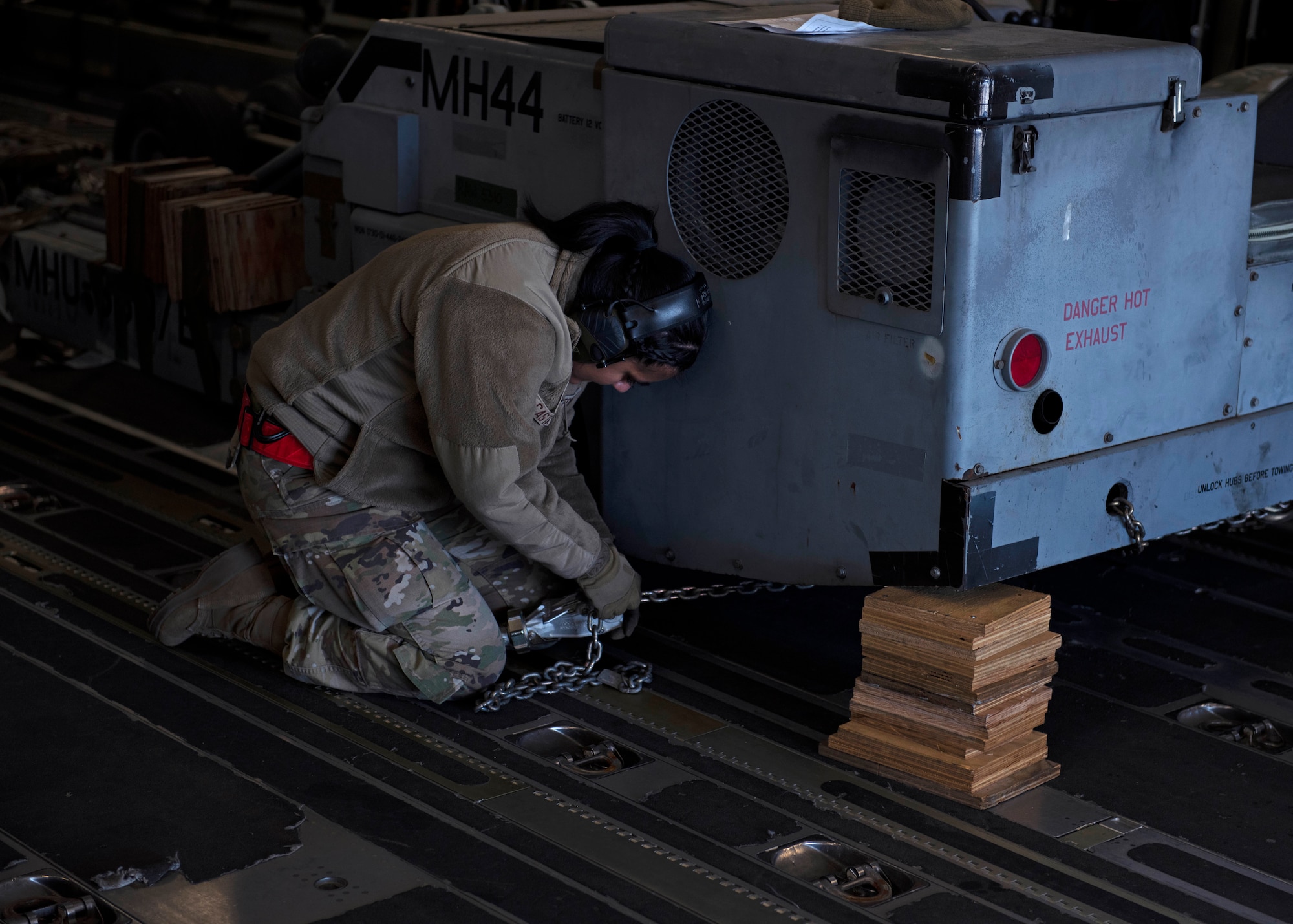U.S. Air Force Airman 1st Class Martha Castaneda, air transportation specialist with the 62d Aerial Port Squadron, secures cargo in a C-17 Globemaster III aircraft during Exercise Rainier War 22B at Mountain Home Air Force Base, Idaho, Oct. 17, 2022. Rainier War 22B is a full-scale readiness exercise with an Air Force Generation prioritization; demonstrating the ability to generate, employ and sustain a combat force during a rigorous wartime scenario. (U.S. Air Force photo by Staff Sgt. Zoe Thacker)