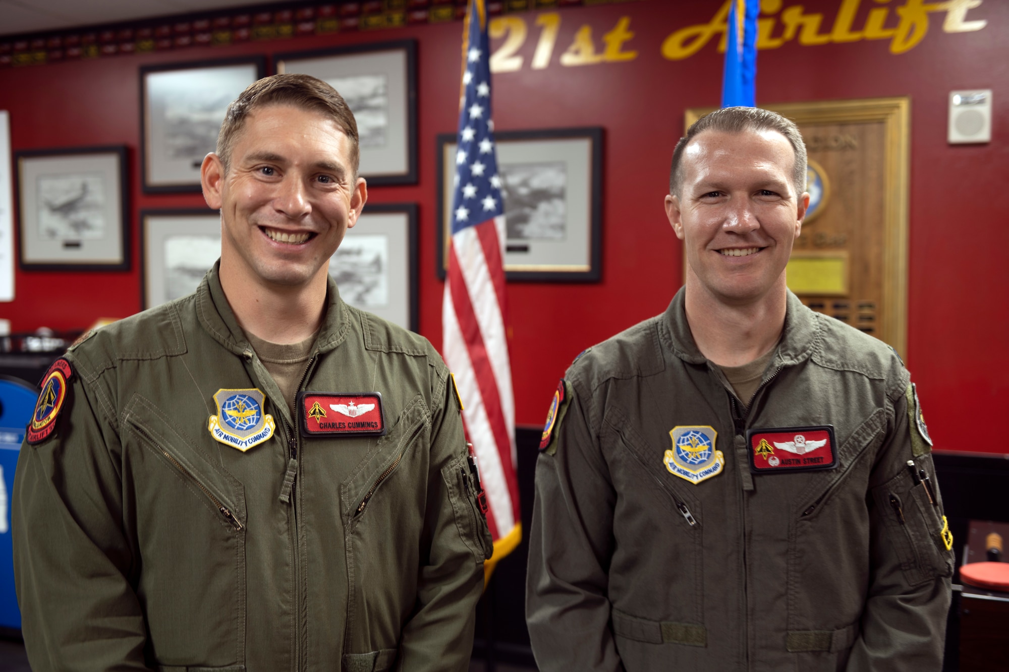 Airmen stand in a room