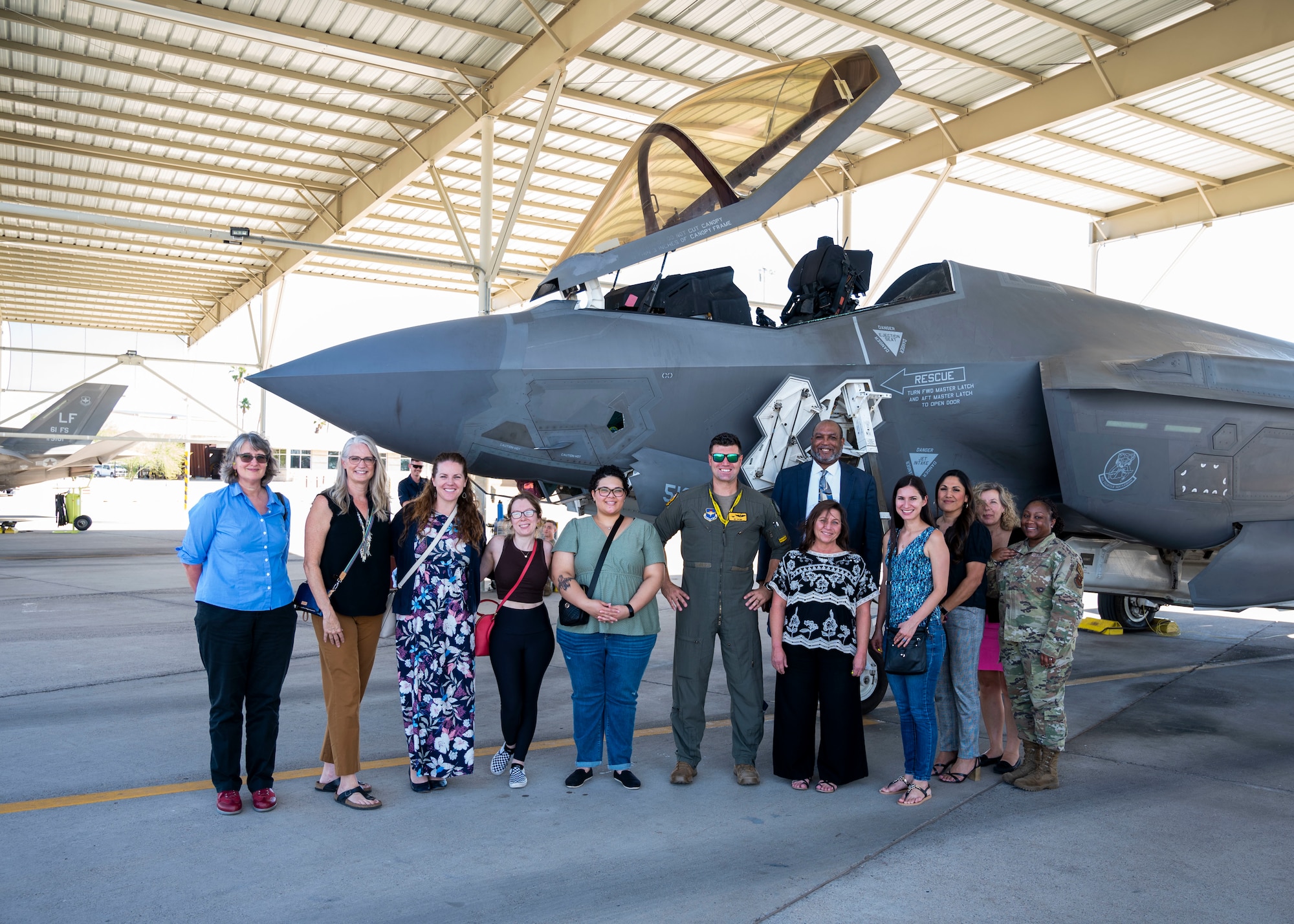 Participants of the Heart Link Spouse Orientation stand in front of a U.S. Air Force F-35A Lightning II aircraft, Oct. 19, 2022, at Luke Air Force Base, Arizona.