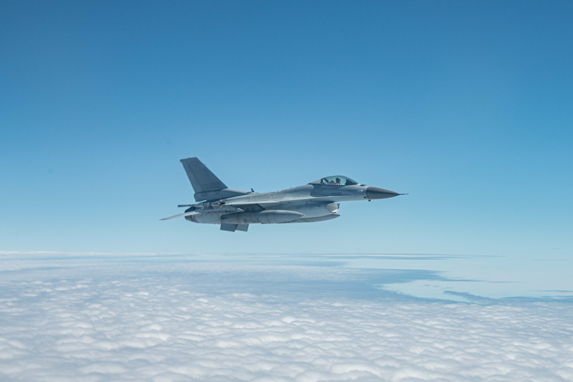 A Korean F-16 flies over clouds