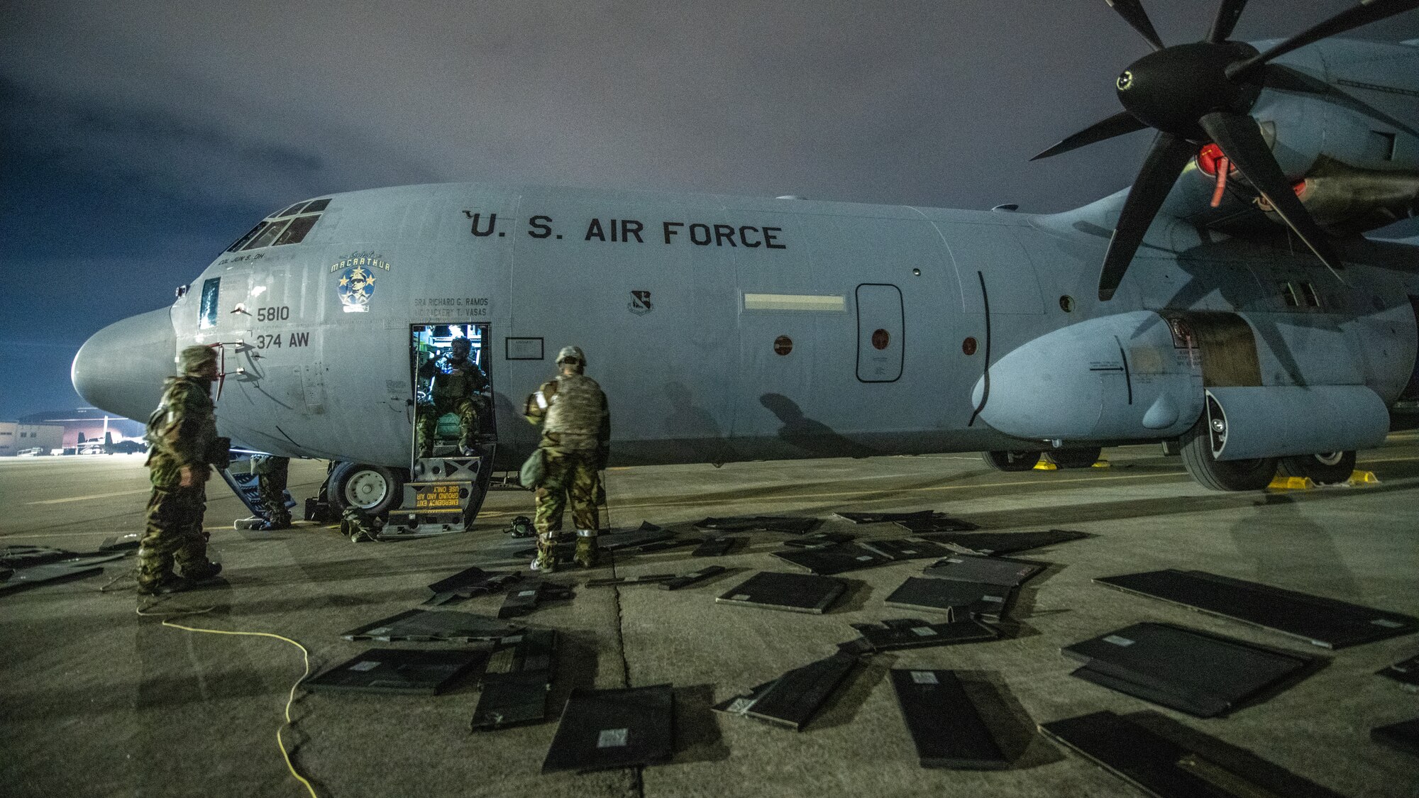 airmen arrange Kevlar plates to be put on a large cargo plane in BG