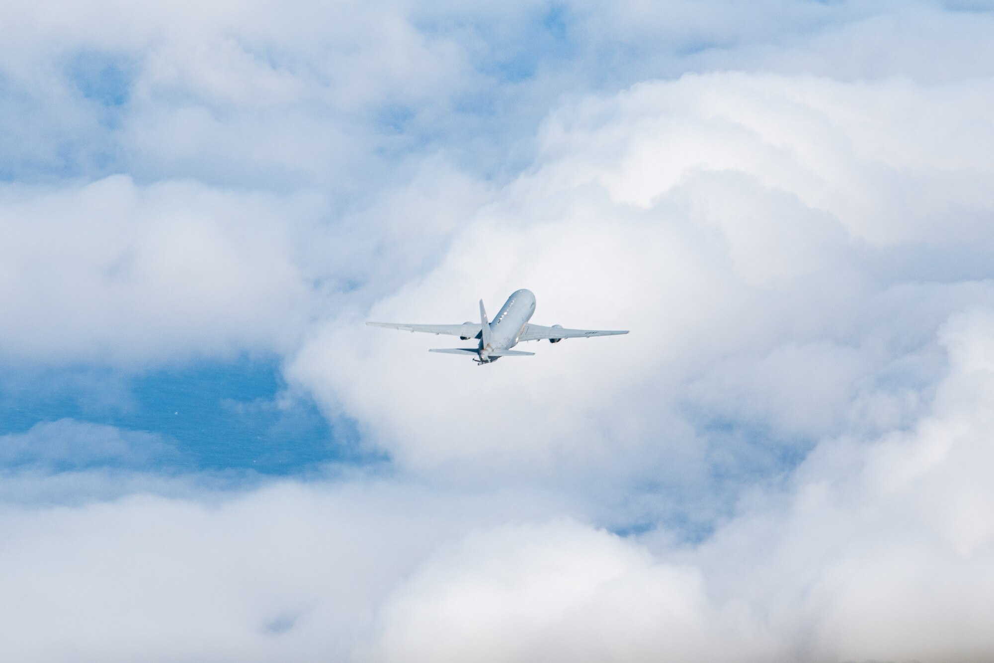 A jet flies through a bunch of clouds