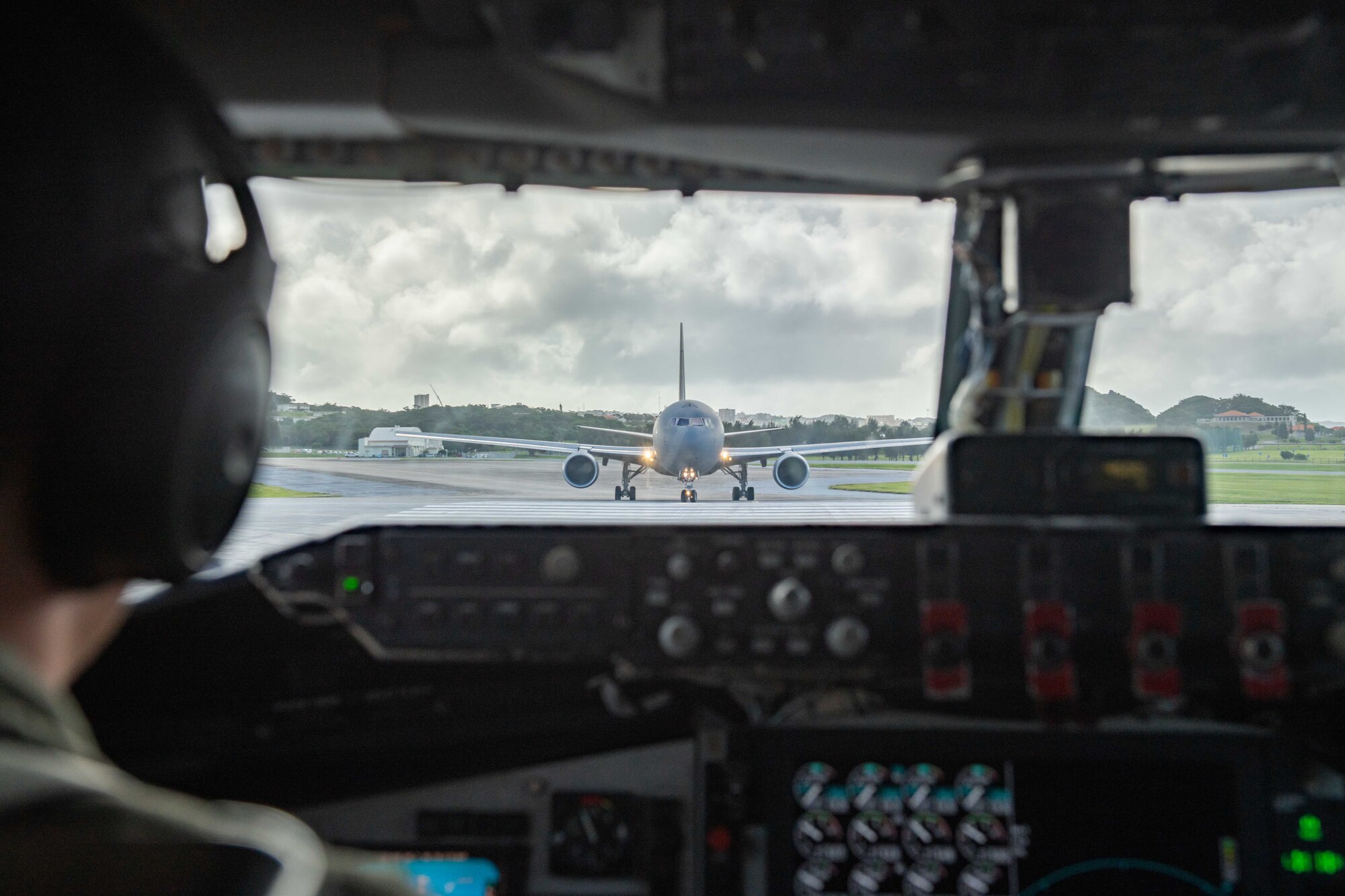A refueling jet pulls out in front of another refueling jet on the flight line