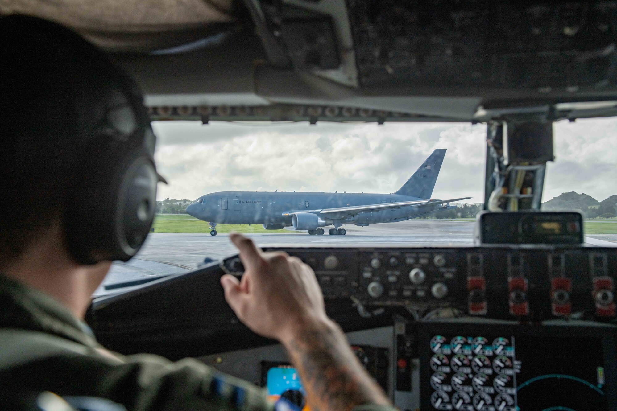 A refueling jet pulls out in front of another refueling jet on the flight line