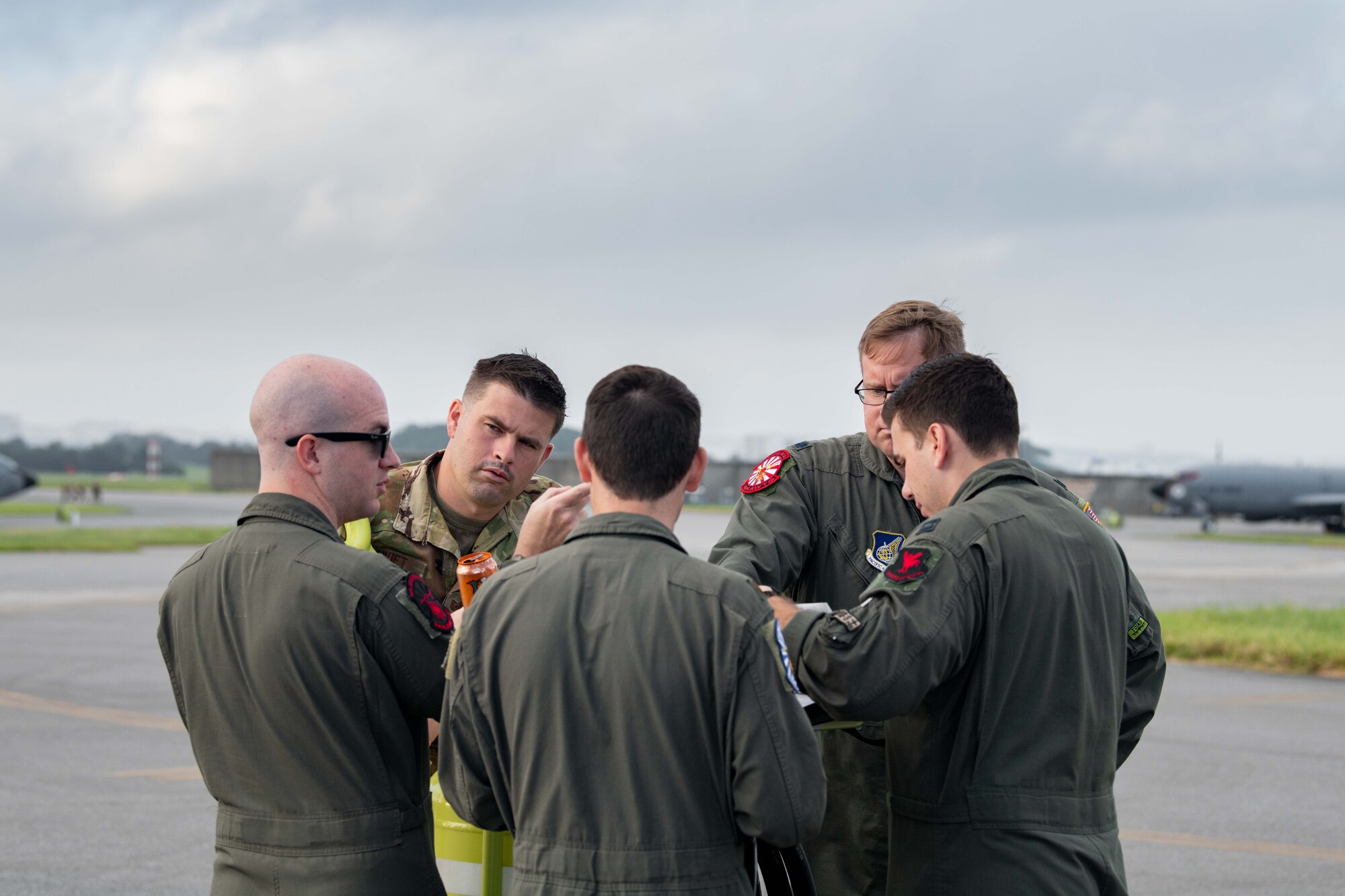 The flight crew gathers together to discuss flight plans