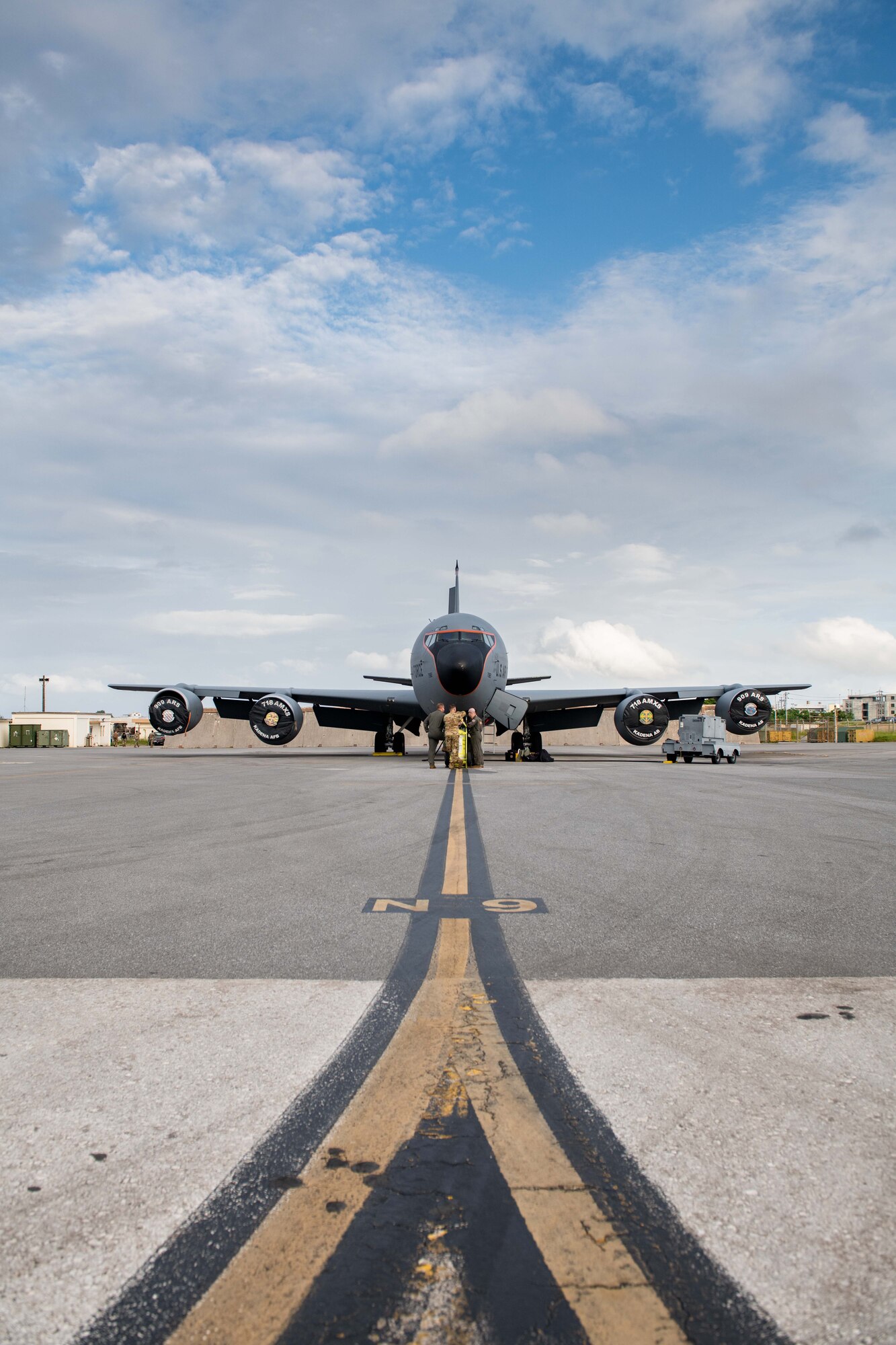 A refueling jet and its crew get ready for a flight