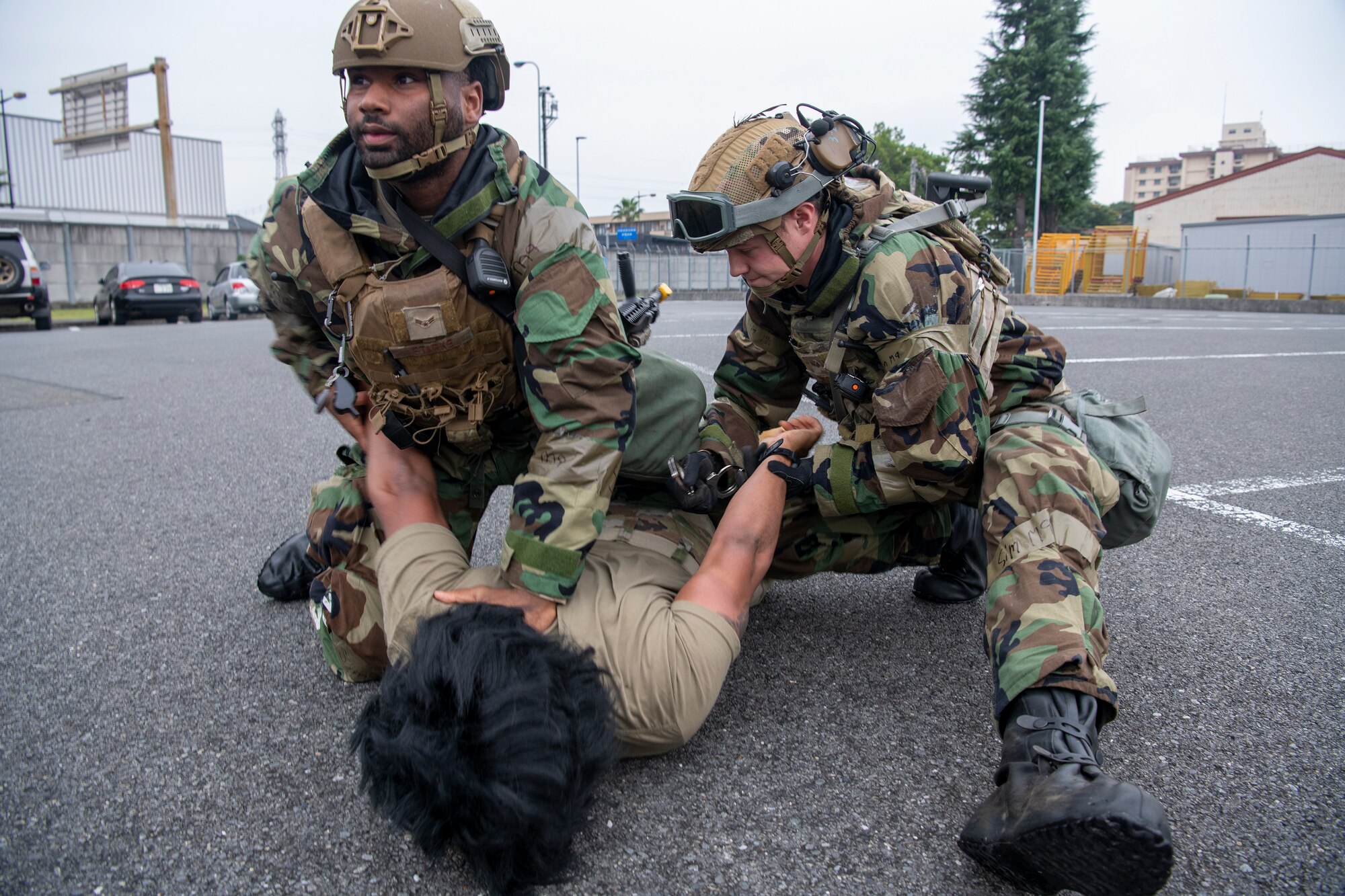 two military police detain a third airman