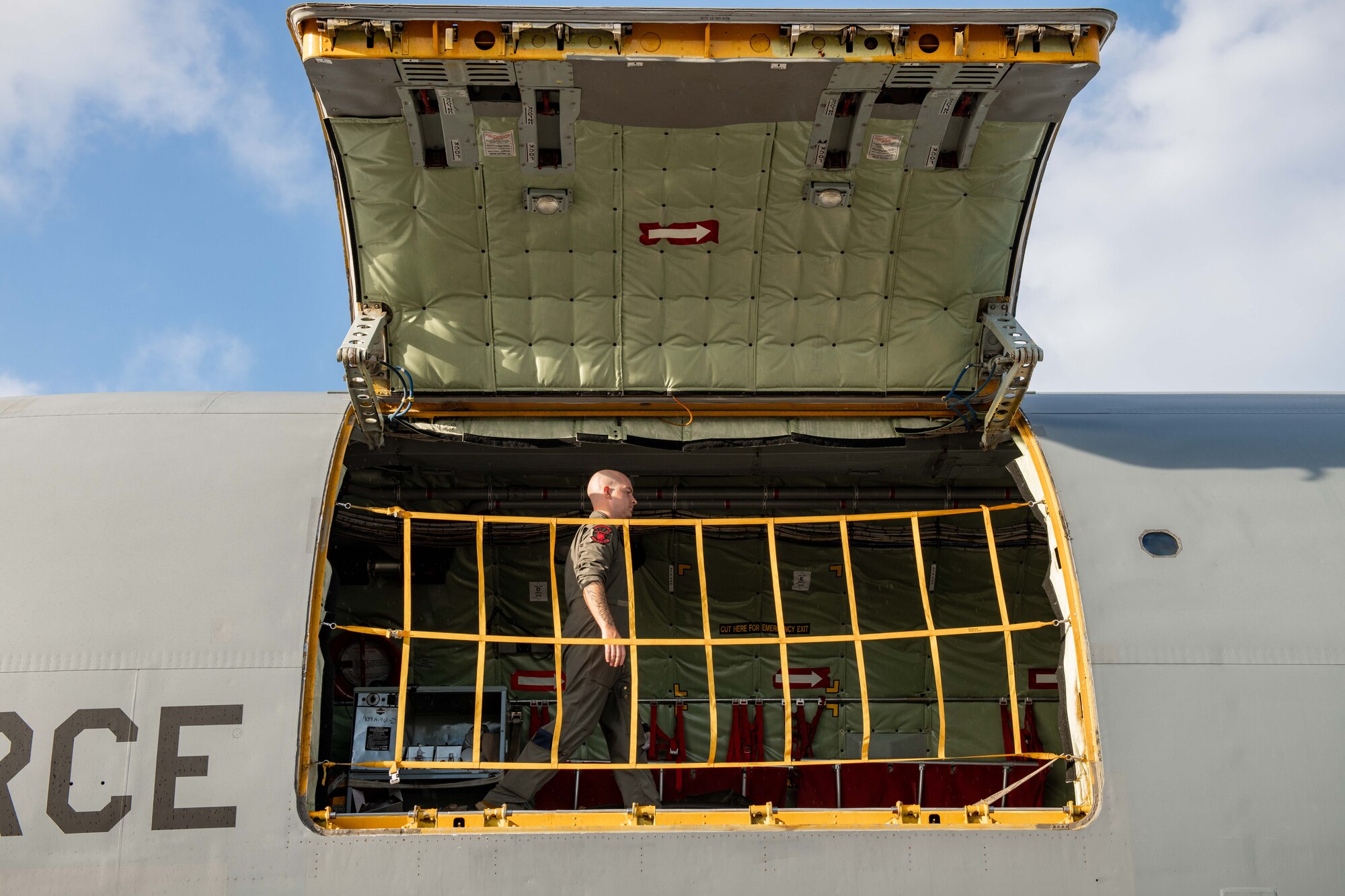 A crewmember walks across a jet