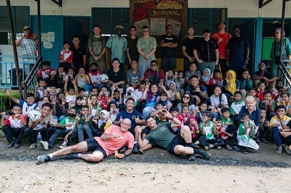 KOTA KINABALU, Malaysia (Oct. 22, 2022) Sailors assigned to Arleigh Burke-class guided-missile destroyer USS Milius (DDG 69) pose for a photo during a community relations event at Etania School for Stateless Children in Kota Kinabalu, Malaysia, during a scheduled port visit, Oct. 22. Milius is assigned to Commander, Task Force 71/Destroyer Squadron (DESRON) 15, the Navy’s largest forward-deployed DESRON and the U.S. 7th Fleet’s principal surface force. (U.S. Navy photo by Mass Communication Specialist 2nd Class Richard Cho)