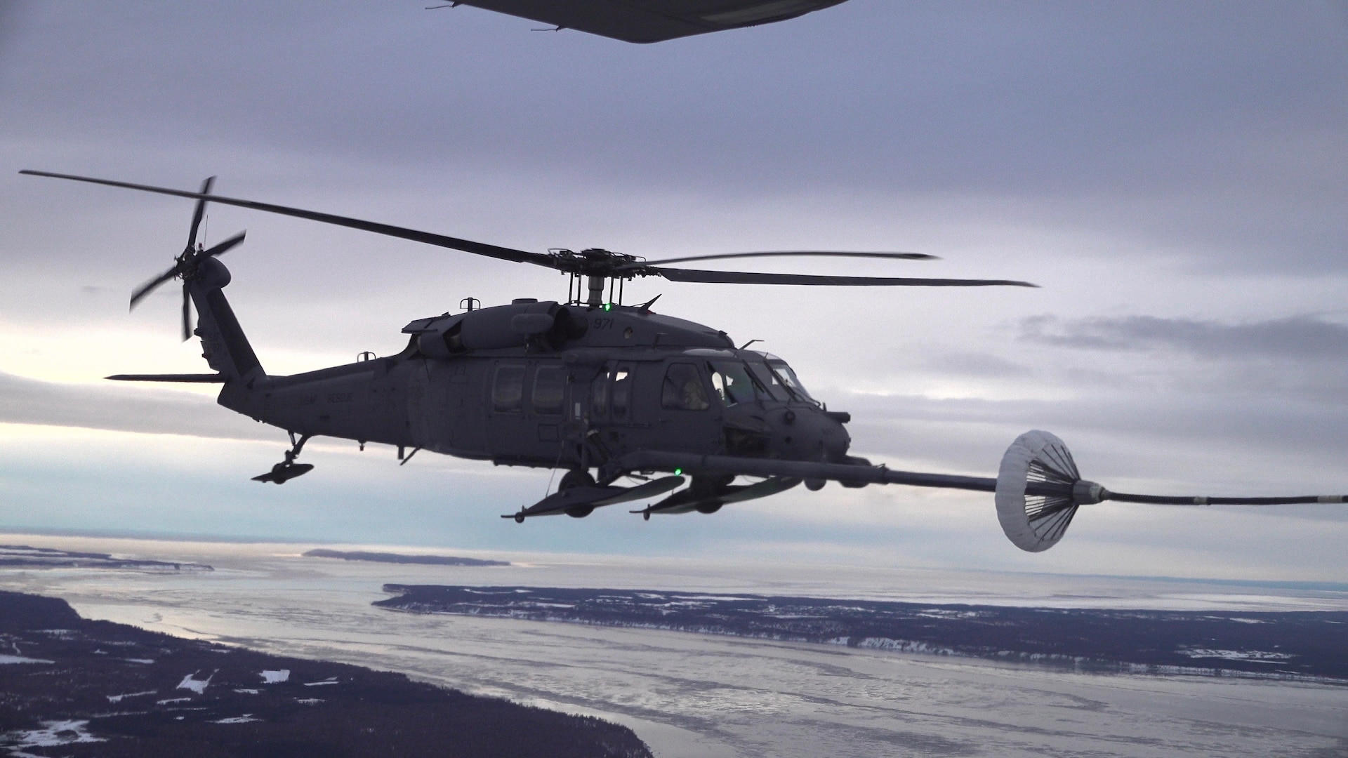 Members of the 210th and 211th Rescue Squadrons, Alaska National Guard, practice aerial refueling in an HH-60G Pave Hawk helicopter over Alaska Jan. 21, 2021. This practice helped prepare members of the unit to execute future rescue missions.