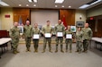 Senior leaders of the Pennsylvania National Guard pose for a photo with the top four finishers of the Pennsylvania National Guard’s 2022 summer photo contest. Winning photos were determined by the PA NG’s social media audience on Facebook and Instagram in a head-to-head tournament-style contest. During the ceremony at Fort Indiantown Gap, Oct. 23, Maj. Gen. Mark Schindler, the Adjutant General of Pennsylvania, presented each Soldier with a certificate of appreciation.