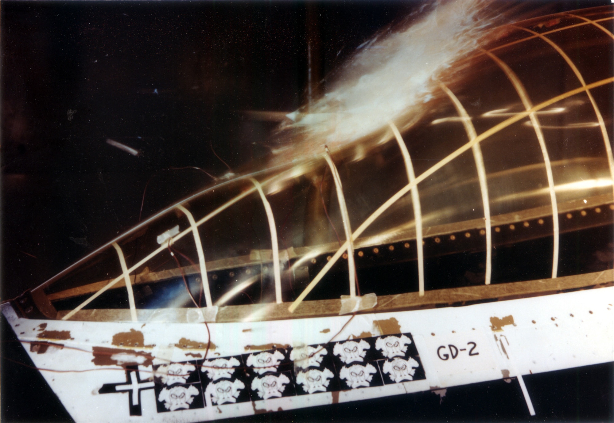 A chicken carcass launched at the Bird Impact Range at Arnold Air Force Base, Tennessee, strikes the canopy of an F-16 Fighting Falcon during bird strike impact testing in 1983. The range, more famously known as the “Chicken Gun,” was used to simulate in-flight bird strikes to aircraft canopies and other materials by launching chicken carcasses at test articles. The first shot from the Chicken Gun was fired 50 years ago. (U.S. Air Force photo)