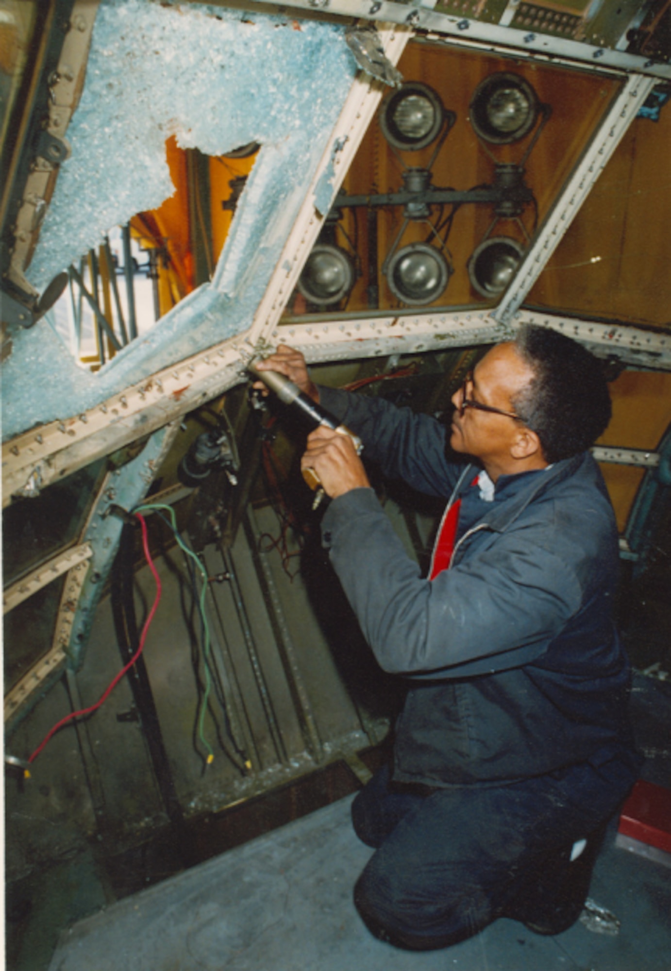 Bill Dillard, an outside machinist master, removes a shattered windshield in a mock C-130 Hercules cockpit tested at the Bird Impact Range at Arnold Air Force Base, Tennessee, in 1995. A chicken carcass fired at the range, most famously known as the “Chicken Gun” broke the windshield during simulated bird strike testing. The facility simulated in-flight bird strikes to aircraft canopies and other materials to aid manufacturers in the redesign and building of such components. The first shot from the Chicken Gun was fired 50 years ago. (U.S. Air Force photo)