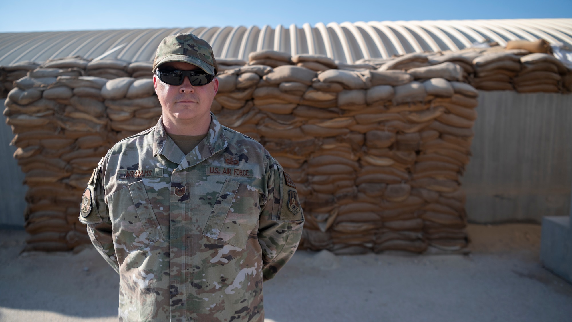 U.S. Air Force Tech. Sgt. Cory Williams, 332d Expeditionary Contracting Squadron, Commodity Flight Chief, stands at parade rest after receiving a commander’s coin from Brigadier General Ryan R. Messer, 332d Air Expeditionary Wing Commander, at an undisclosed location, Southwest Asia, Oct. 11, 2022. Tech. Sgt. Williams was recognized as a superior performer for his end-of-year fiscal contributions to the 332d AEW. (U.S. Air Force photo by Tech. Sgt. Jeffery Foster)