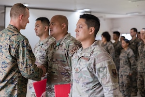 U.S. Air Force Tech. Sgt. Cesar Salilican, Master Sgt. Ramchand Francisco, and Capt. Timothy Nolan, Tagalog interpreters attached to the 11th Marine Expeditionary Unit, pose for a photo at Camp Rudolfo Punsalang, Palawan, Philippines, Oct. 14, 2022. Thanks to a partnership between the United States Marine Corps and the Language Enabled Airman Program, the Airmen embedded with the 11th MEU Command Element as Tagalog interpreters during exercise KAMANDAG 6 at Marine Base Rudolfo Punsalang, Palawan, Philippines. (U.S. Marine Corps photo By Sgt. Dana Beesley)