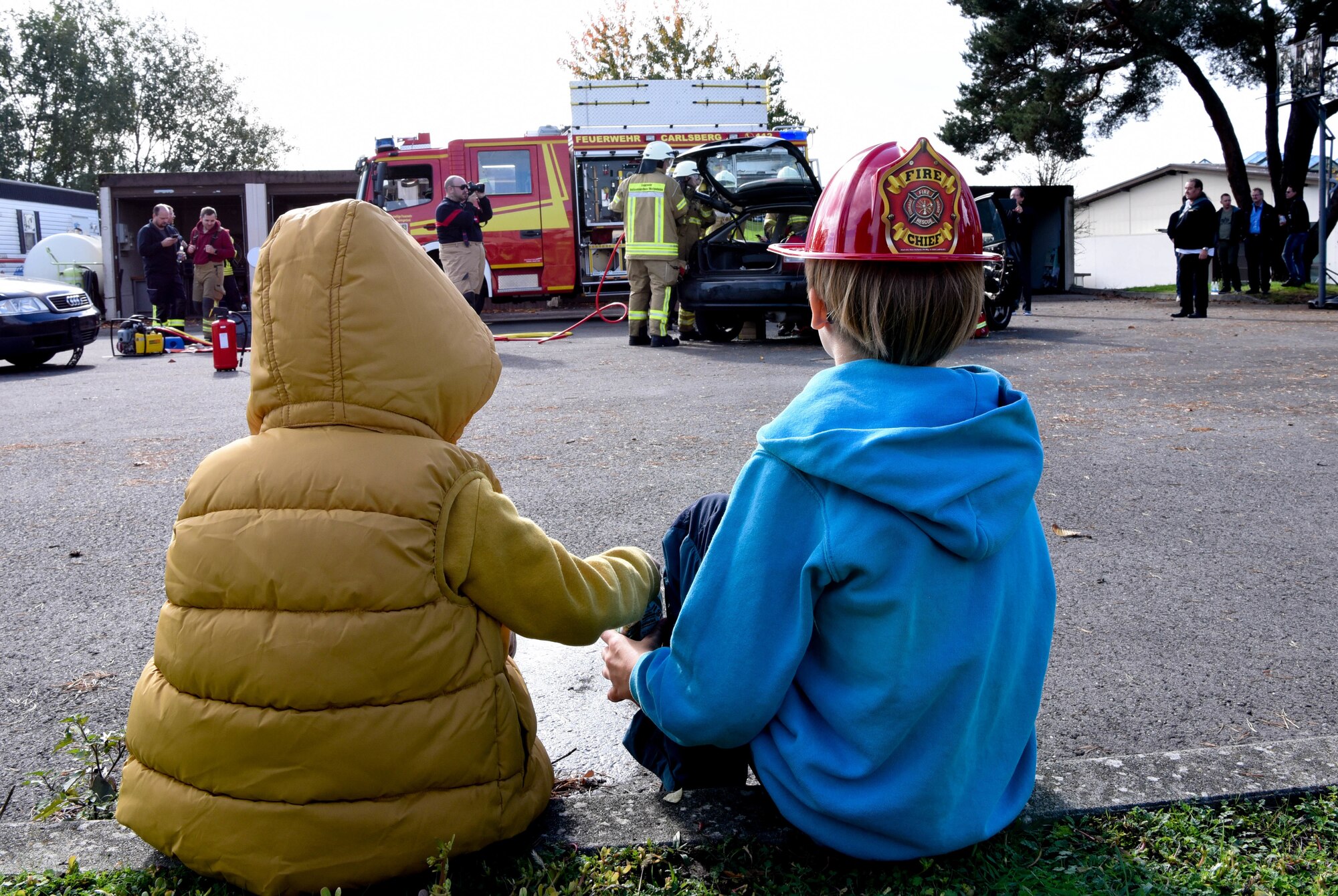 Children watch an extraction demonstration during an 86th Civil Engineer Squadron Fire Prevention Week open house at Ramstein Air Base
