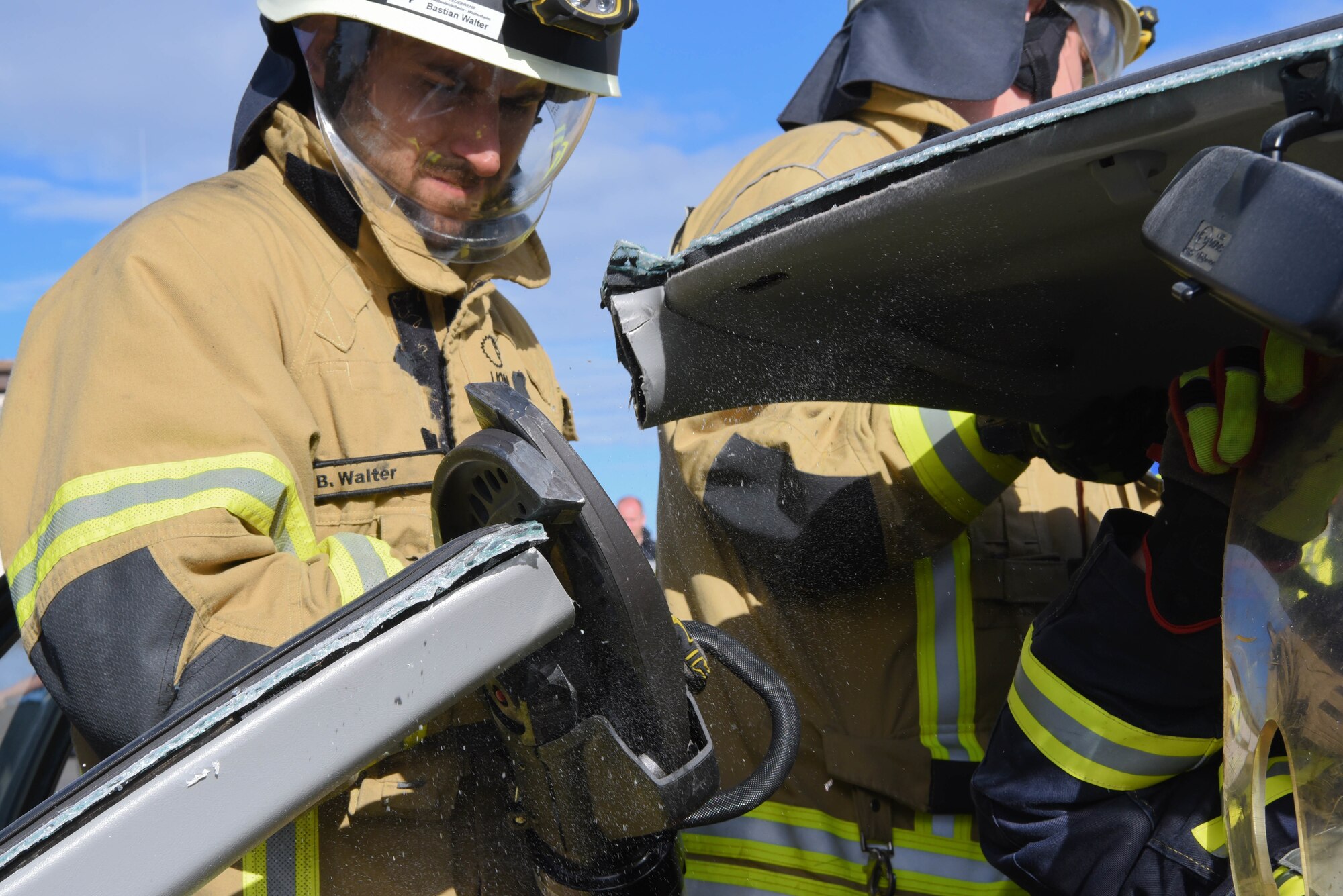A firefighter from the Carlsberg and Hettenleidelheim fire department uses the Jaws of Life to demonstrate a vehicle extraction during an 86th Civil Engineer Squadron fire department Fire Prevention Week open house at Ramstein Air Base
