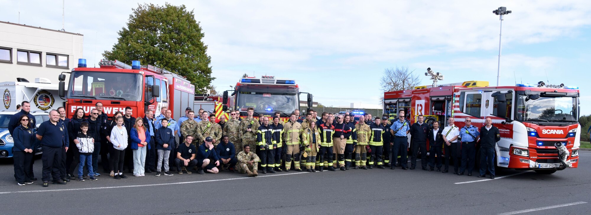 Service Members from the 86th Civil Engineer Squadron fire department and local German firefighters pose for a photo during a Fire Prevention Week open house at Ramstein Air Base