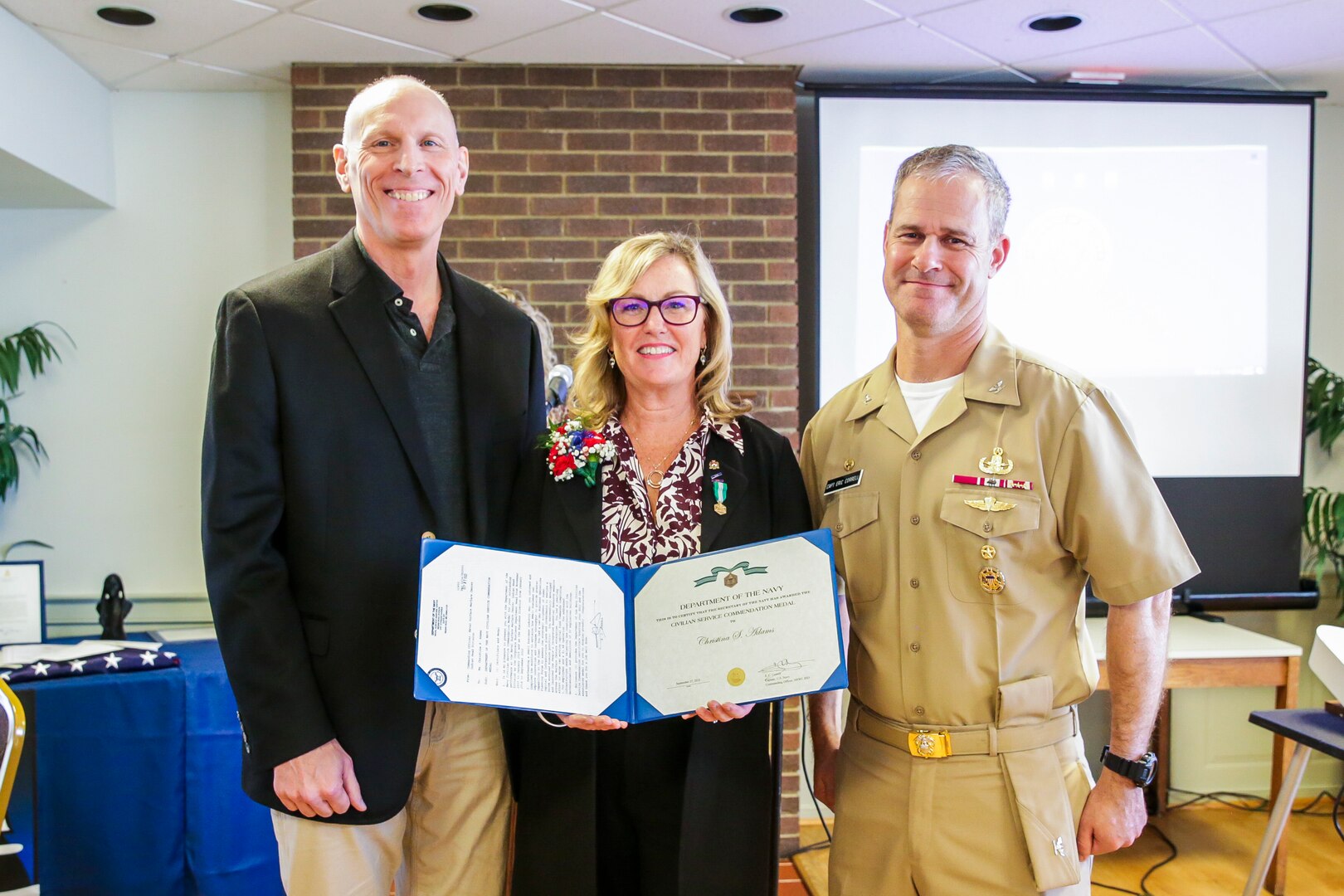 Former NSWC IHD Business Director Christina Adams poses with the Civilian Service Commendation Medal alongside NSWC IHD Technical Director Ashley Johnson and Commanding Officer Capt. Eric Correll during her retirement ceremony, Sept. 29.