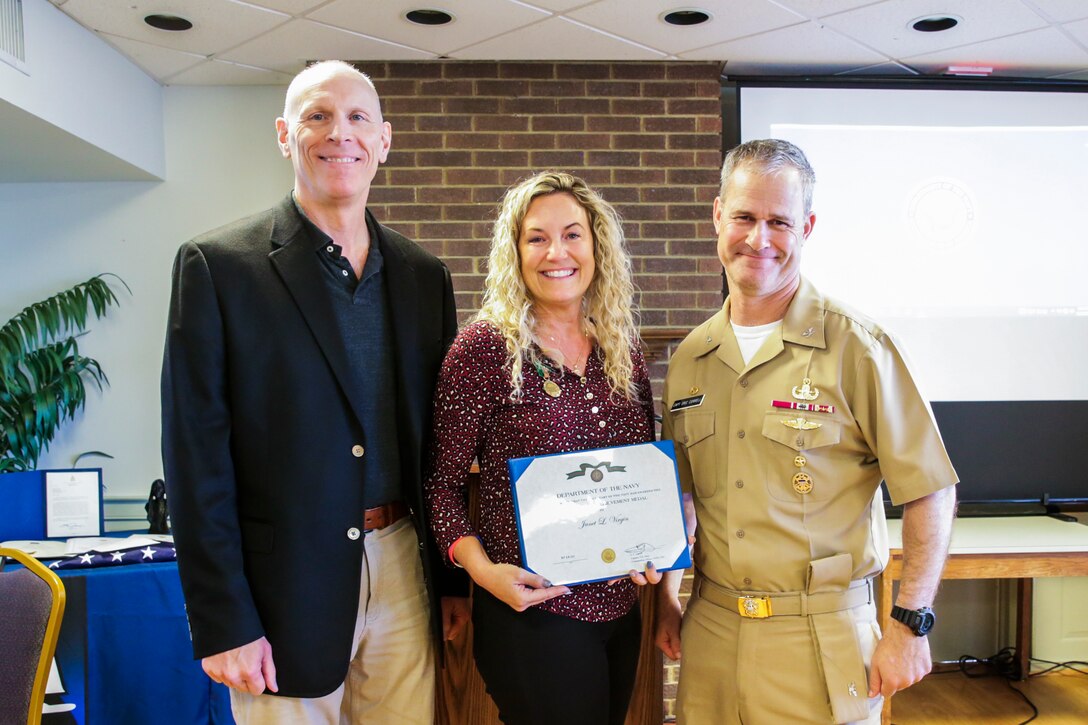 NSWC IHD Protocol Officer Janet Virgin poses with the Civilian Service Achievement Medal alongside NSWC IHD Technical Director Ashley Johnson and Commanding Officer Capt. Eric Correll, Sept. 29.
