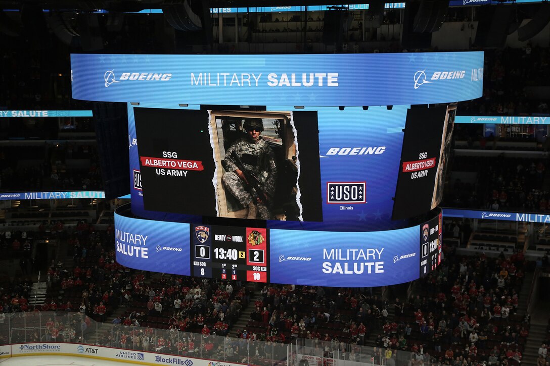 A photo of U.S. Army Reserve Staff Sgt. Alberto Vega, Information Technology Specialist, 85th U.S. Army Reserve Support Command, is displayed on the jumbotron during the Chicago Blackhawks home game versus the Florida Panthers, October 25, 2022.