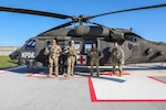 Left to right, U.S. Army Sgts. Jon Atcitty and Jacob Anderson, inflight paramedics; Chief Warrant Officer 3 Robert Anderson, pilot in command; and Chief Warrant Officer 2 John Carey, second pilot in command, all assigned to Charlie Company, 2nd Battalion, 149th Aviation Regiment, Arizona National Guard, in front of their UH-60 Black Hawk medevac helicopter at Camp Bondsteel, Kosovo, Oct. 21, 2022. Their unit is supporting ongoing operations in Kosovo Force’s Regional Command-East.