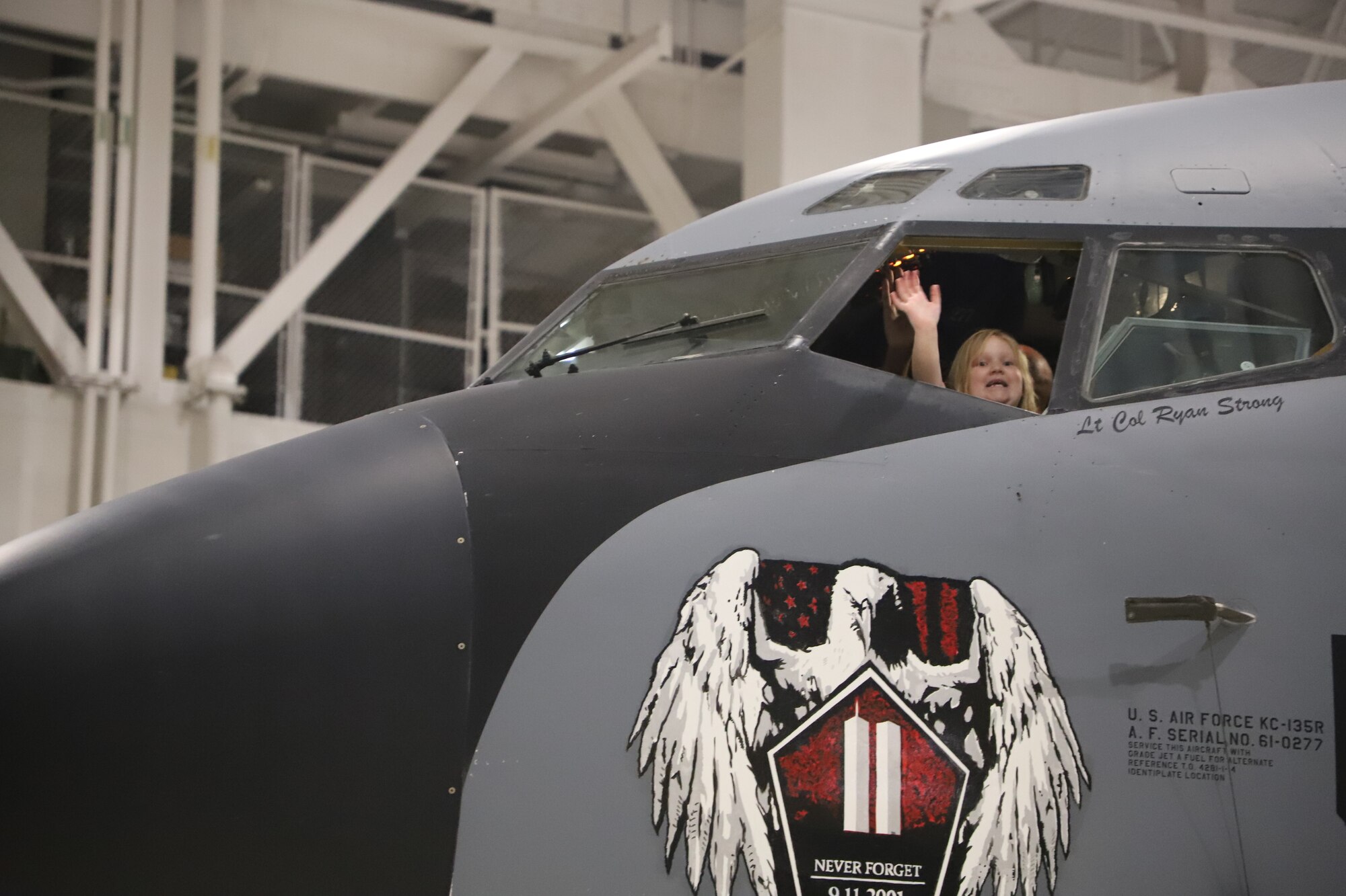 Tinley Benyshek, Pilot for the Day, waves out the pilot window on a KC-135 at the 190th Air Refueling Wing in Topeka, KS, October 24, 2022. Tinley is the first Pilot for a Day participant at the 190th ARW.