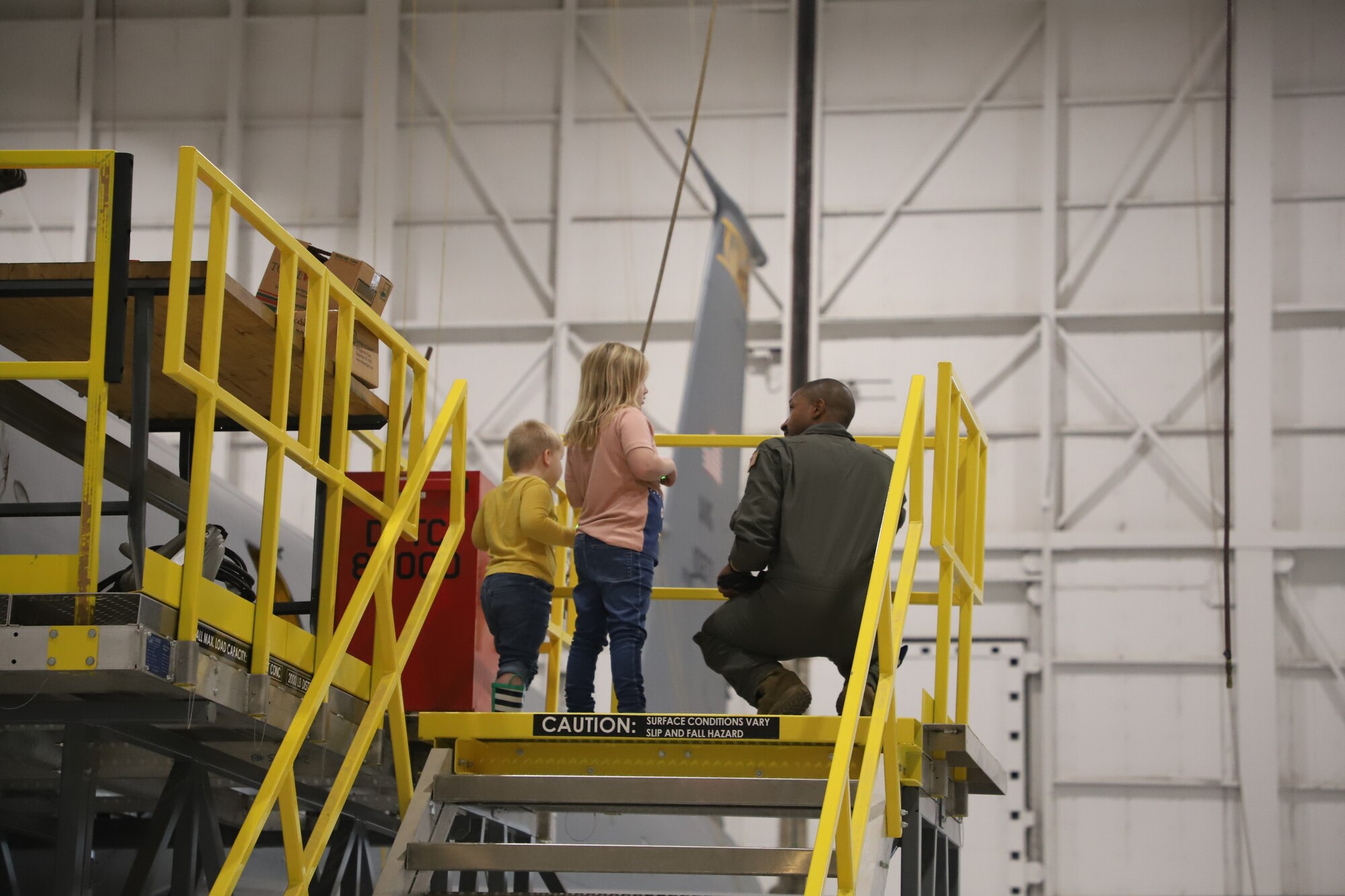 Tinley Benyshek, Pilot for the Day, and her brother, Trip, talk with Major Sterling Scales about the KC-135 at the 190th Air Refueling Wing in Topeka, KS, October 24, 2022. Tinley is the first Pilot for a Day participant at the 190th ARW.