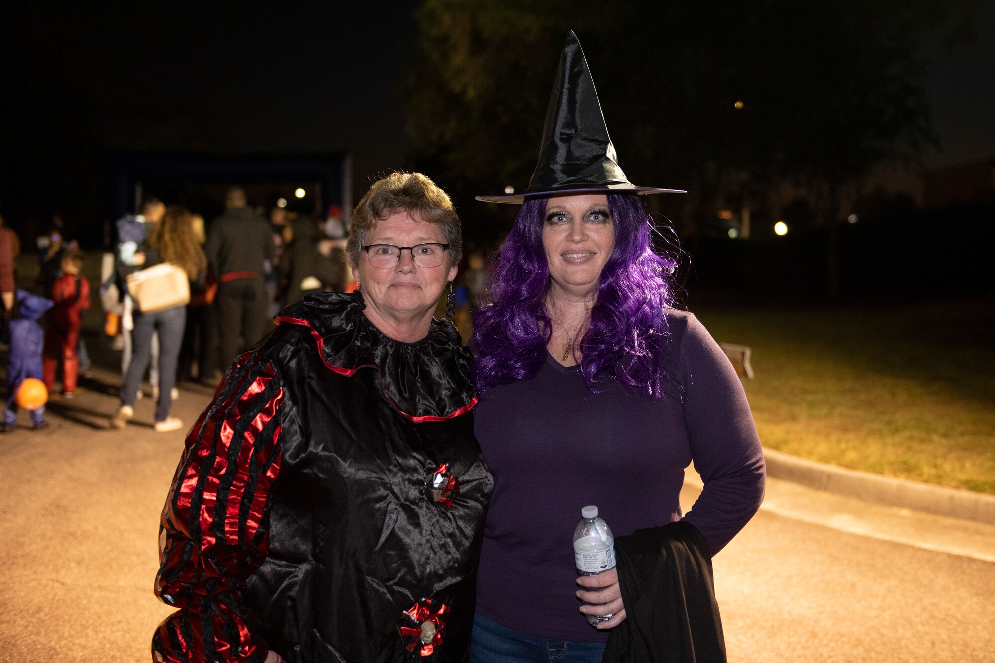 A photo of two women dressed in costumes posing for a photo.