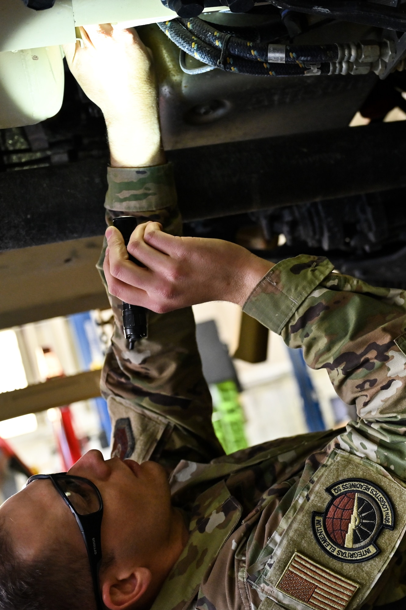 Senior Airman Korey Sarantopoulos, 90th Logistics Readiness Squadron vehicle maintenance journeyman, inspects the undercarriage to check the electrical, brake, fuel, cooling and other systems for serviceability as part of a Joint Light Tactical Vehicle limited technical inspection at F.E. Warren Air Force Base, Wyoming, Oct 25, 2022. The 90 LRS is tasked with preparing the next generation of security forces vehicles sent to protect the 90th Missile Wing's ICBM system as part of Air Force Global Strike Command’s priority to modernize. (U.S. Air Force photo by Joseph Coslett)