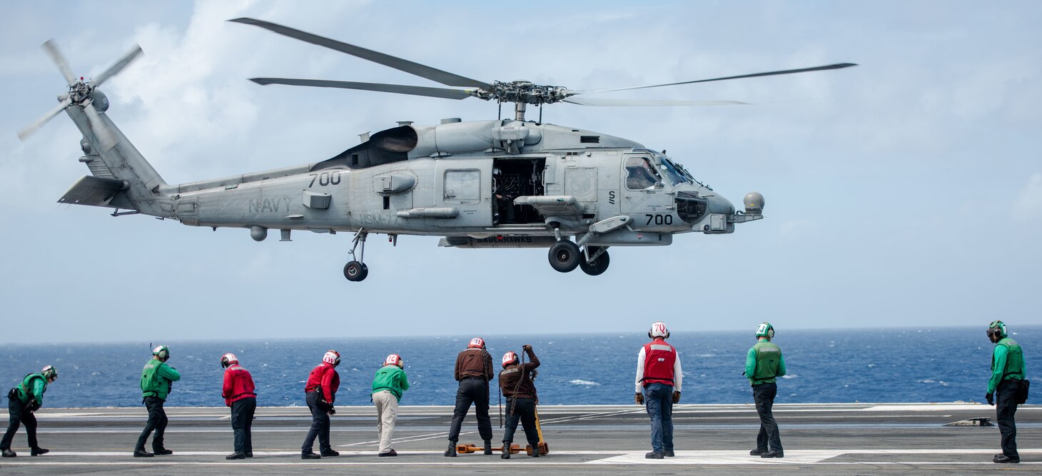 PHILIPPINE SEA (Oct. 27, 2022) An MH-60R Sea Hawk, attached to the Saberhawks of Helicopter Maritime Strike Squadron (HSM) 77, takes off from the flight deck of the U.S. Navy’s only forward-deployed aircraft carrier, USS Ronald Reagan (CVN 76), in the Philippine Sea, Oct. 27. HSM 77’s missions include surface warfare, anti-submarine warfare, and a variety of support roles for Ronald Reagan and Carrier Strike Group (CSG) 5. Ronald Reagan, the flagship of CSG 5, provides a combat-ready force that protects and defends the United States, and supports alliances, partnerships and collective maritime interests in the Indo-Pacific region. (U.S. Navy photo by Mass Communication Specialist 3rd Class Eric Stanton)
