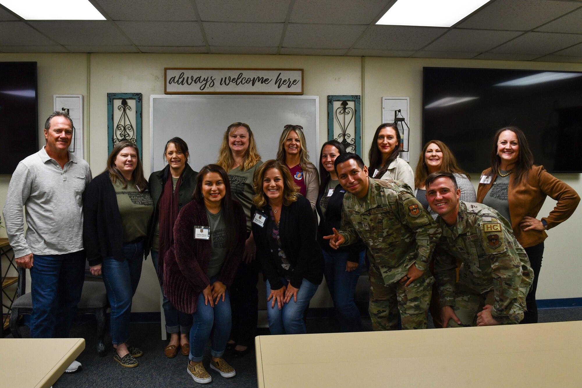 Leadership spouses from the 97th Air Mobility Wing pose for a photo with members of the community support group during a leadership spouse tour at Altus Air Force Base, Oklahoma, Oct. 19, 2022. Community and recreation programs are designed to promote fitness, maintain mission readiness and create a strong sense of military community that enhances the quality of life. (U.S. Air Force photo by Airman 1st Class Miyah Gray)