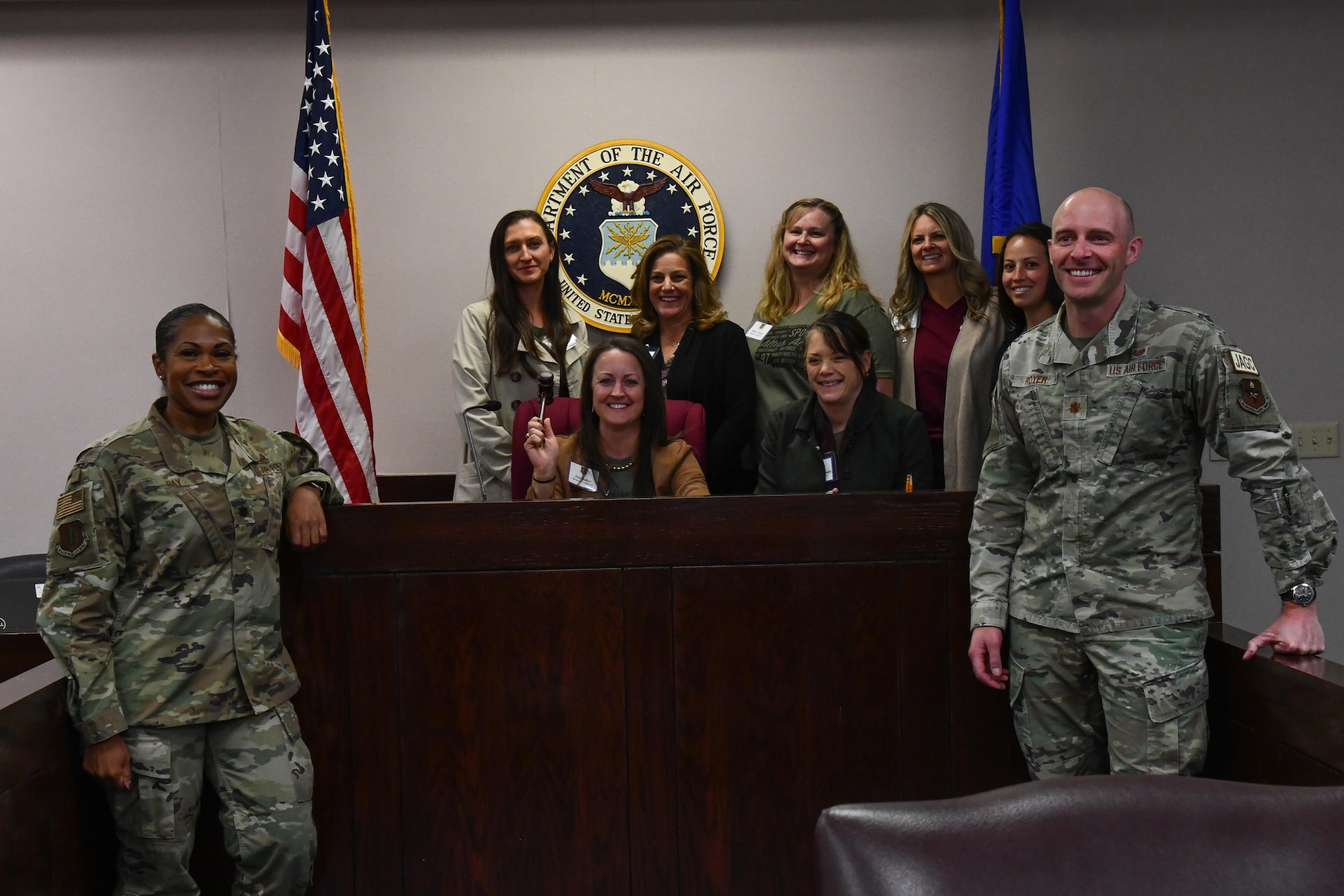 Leadership spouses from the 97th Air Mobility Wing pose for a photo with members of the 97th Air Mobility Wing Judge Advocate staff at Altus Air Force Base, Oklahoma, Oct. 19 2022. The Judge Advocate Office staff offers free professional legal advice concerning a wide range of civil legal matters. (U.S. Air Force photo by Airman 1st Class Miyah Gray)