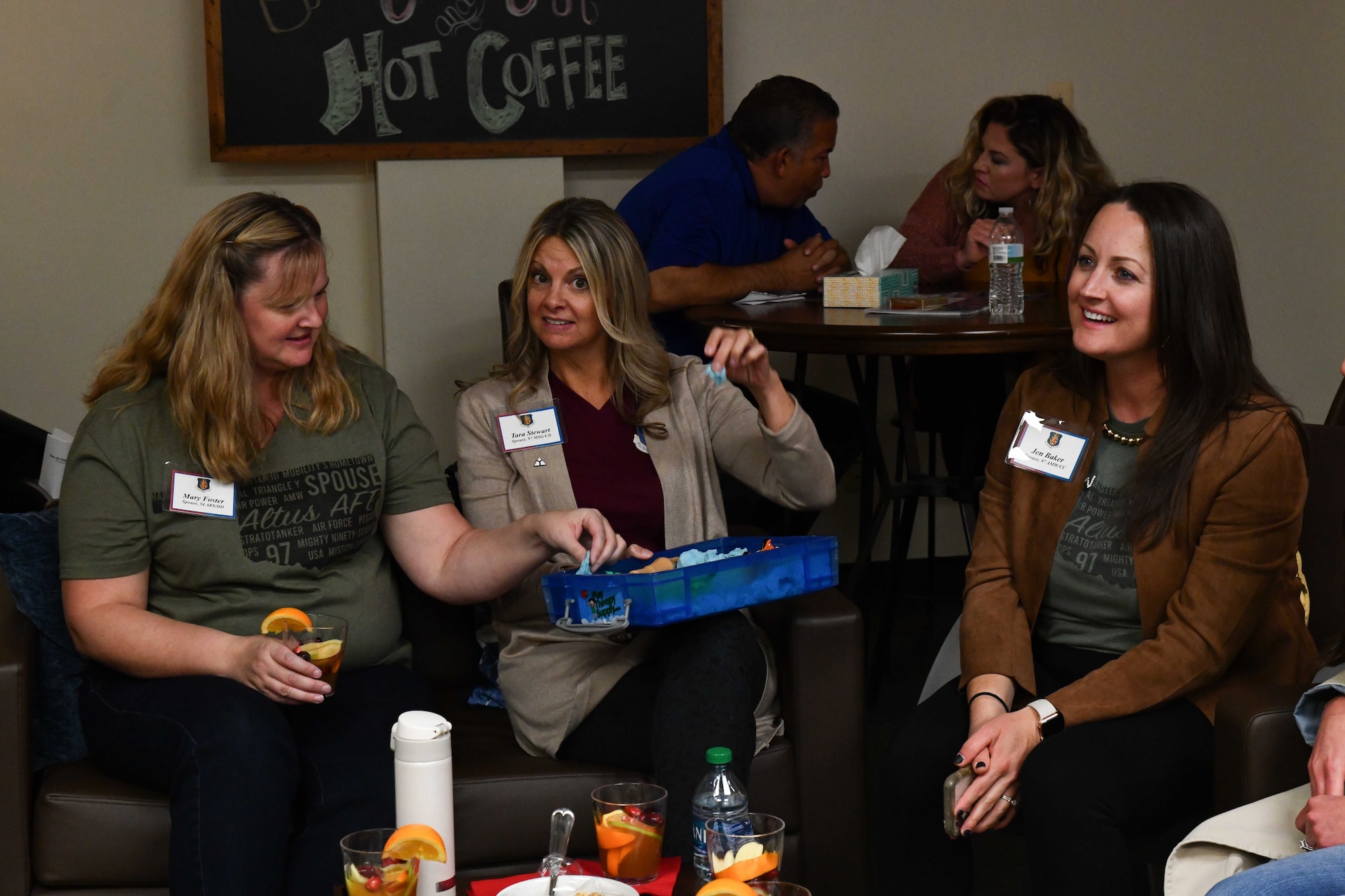 Leadership spouses from the 97th Air Mobility Wing play with sand during a spouse tour at Altus Air Force Base, Oklahoma, Oct. 19, 2022. The sand is one of many “fidgets” at the Military and Family Readiness Center used to help improve focus and expel energy. (U.S. Air Force photo by Airman 1st Class Miyah Gray)