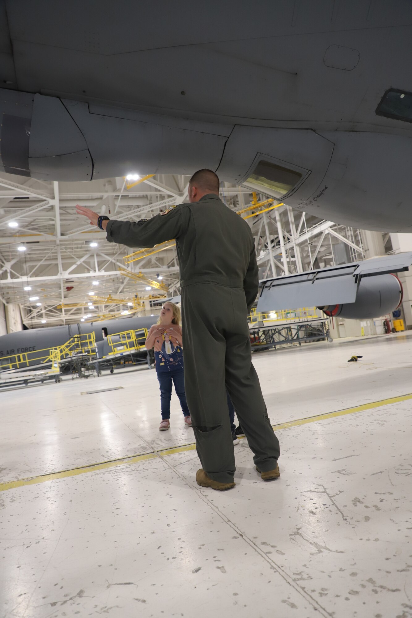 Tinley Benyshek, Pilot for the Day, is shown underneath a KC-135 by SMSgt Nathan Neidhardt, senior evaluator boom at the 190th Air Refueling Wing in Topeka, KS, October 24, 2022. Tinley is the first Pilot for a Day participant at the 190th ARW.