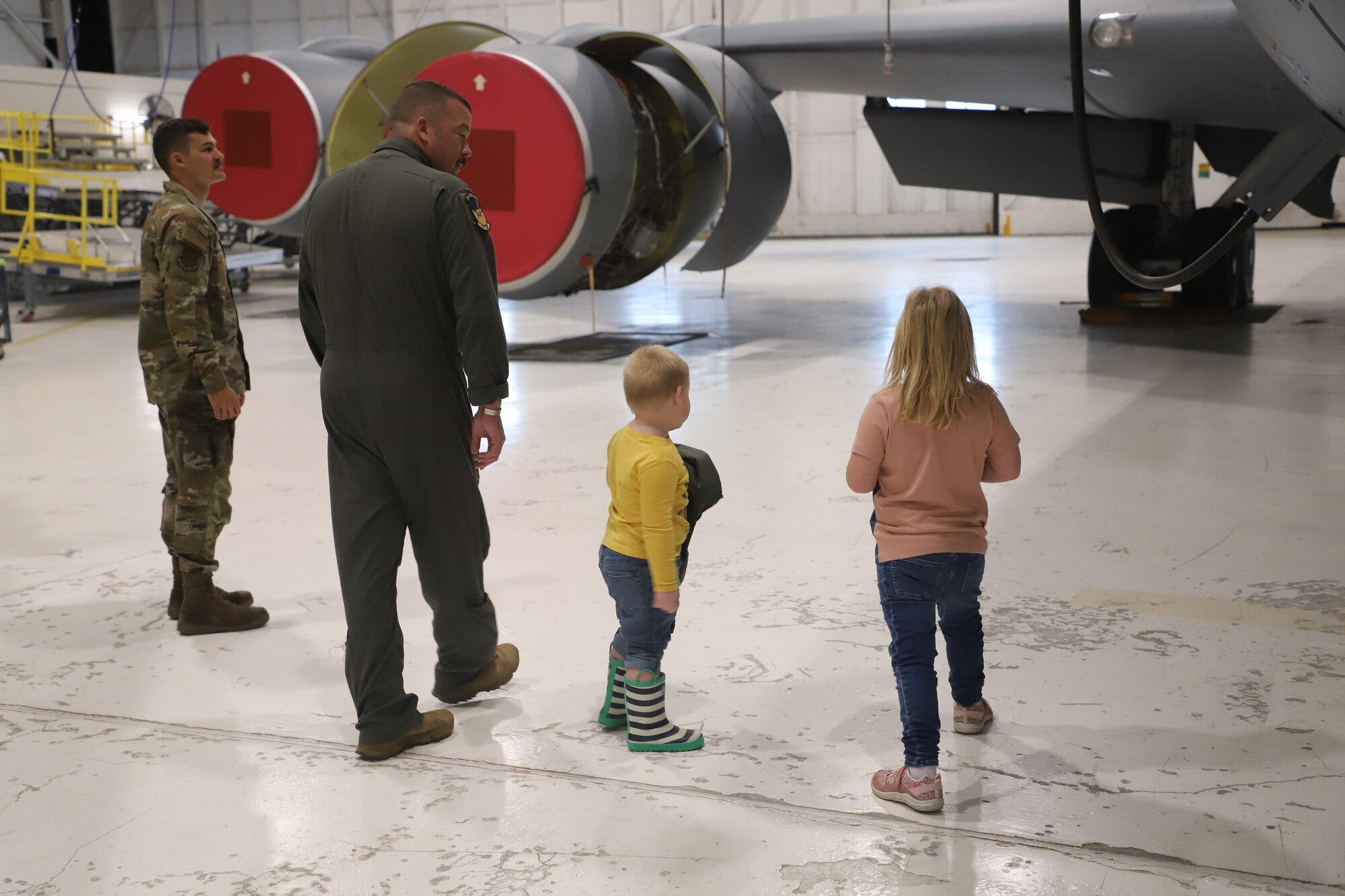 Tinley Benyshek, Pilot for the Day, and her brother, Trip, are shown the wings of a KC-135 by SMSgt Nathan Neidhardt, Senior Evaluator Boom at the 190th Air Refueling Wing in Topeka, KS, October 24, 2022. Tinley is the first Pilot for a Day participant at the 190th ARW.