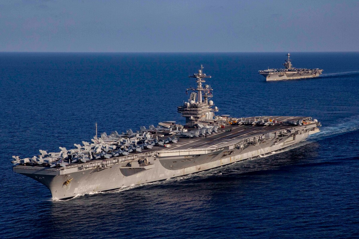 Two large ships traverse an ocean.