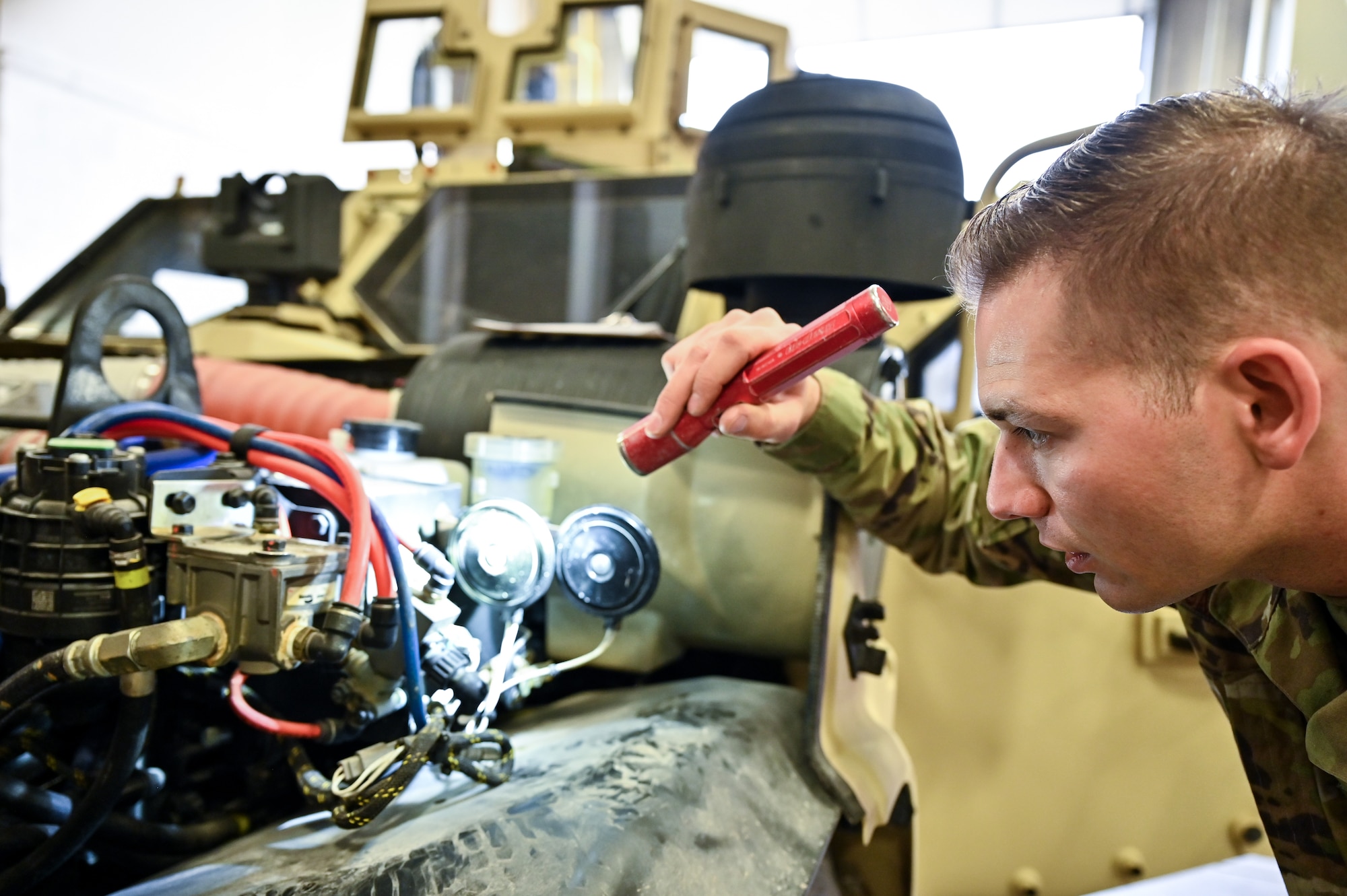 Senior Airman Korey Sarantopoulos, 90th Logistics Readiness Squadron vehicle maintenance journeyman, checks the electrical, brake, fuel, cooling and other systems for serviceability as part of a Joint Light Tactical Vehicle limited technical inspection at F.E. Warren Air Force Base, Wyoming, Oct 25, 2022. The 90 LRS is tasked with preparing the next generation of security forces vehicles sent to protect the 90th Missile Wing's ICBM system as part of Air Force Global Strike Command’s priority to modernize. (U.S. Air Force photo by Joseph Coslett)